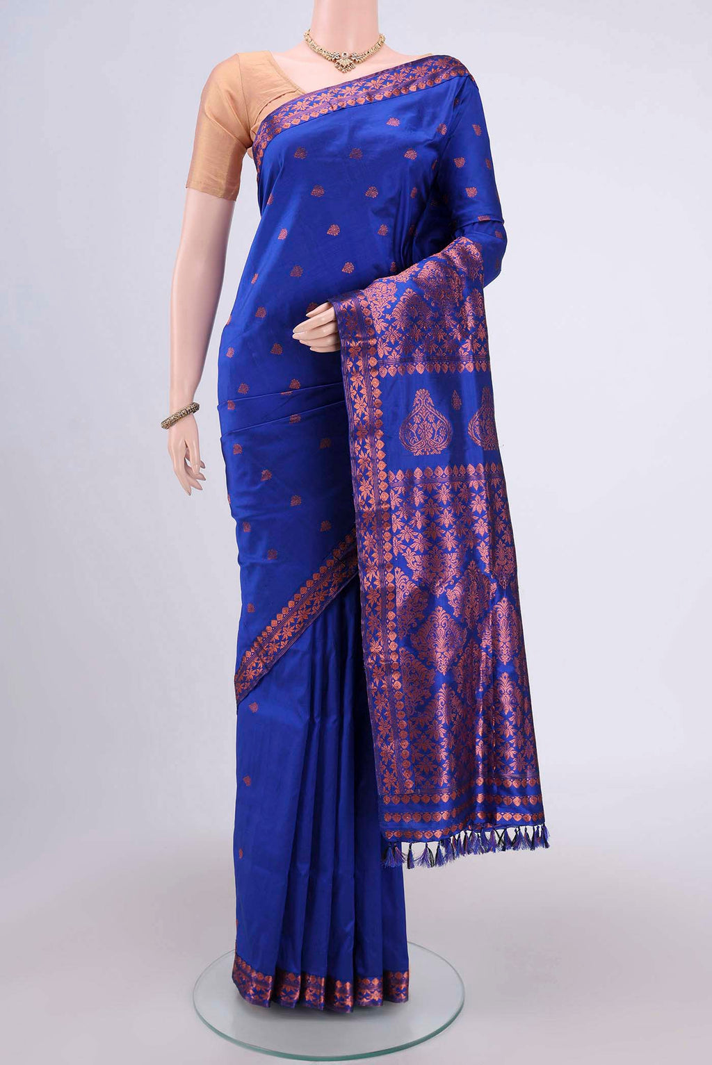 Navy Blue Assam Silk Saree with Zari Butta on the body and Zari Border.  displayed on a mannequin