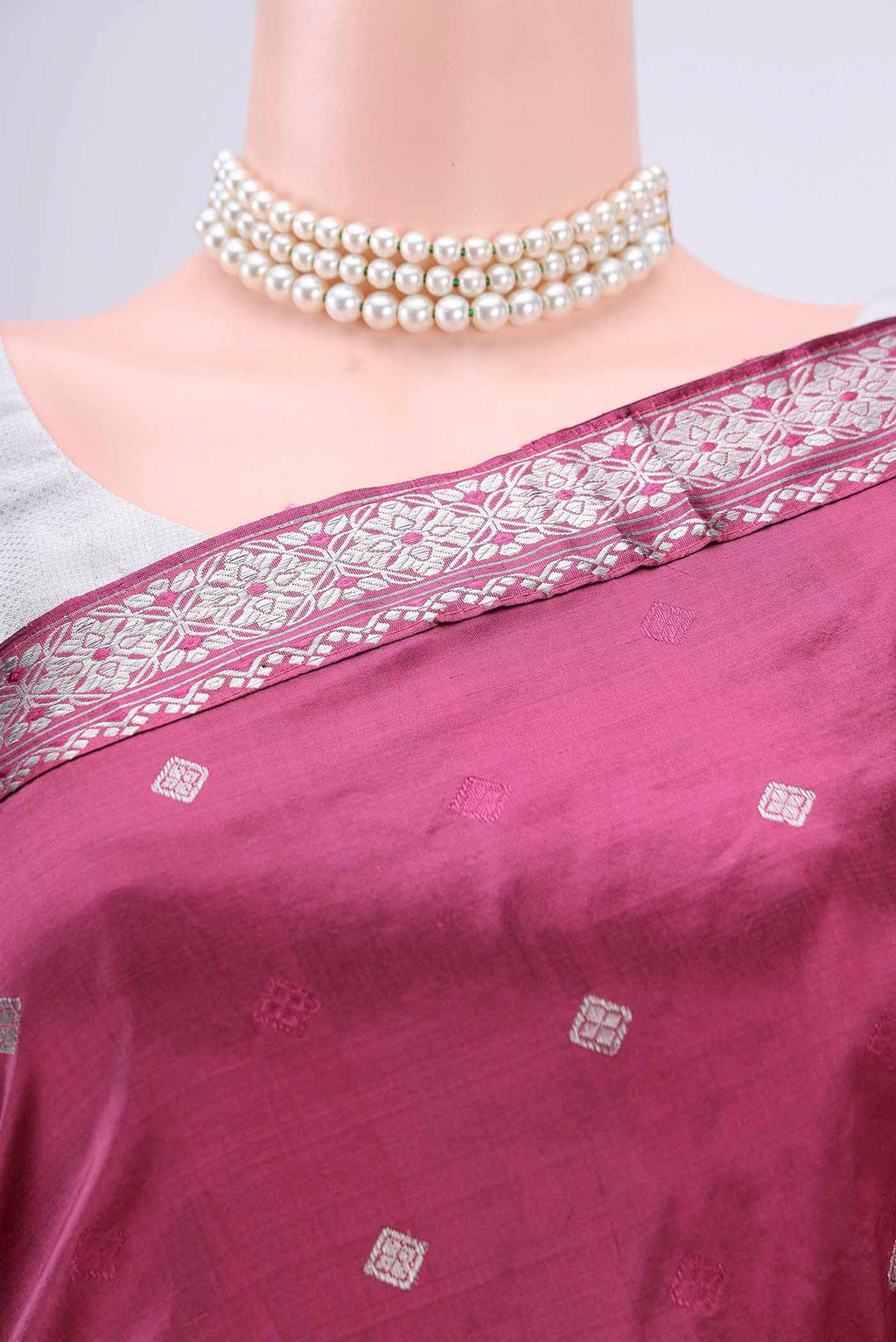 Border image of Pink Assam Silk Saree with Zari Butta on the body and Zari Border. 