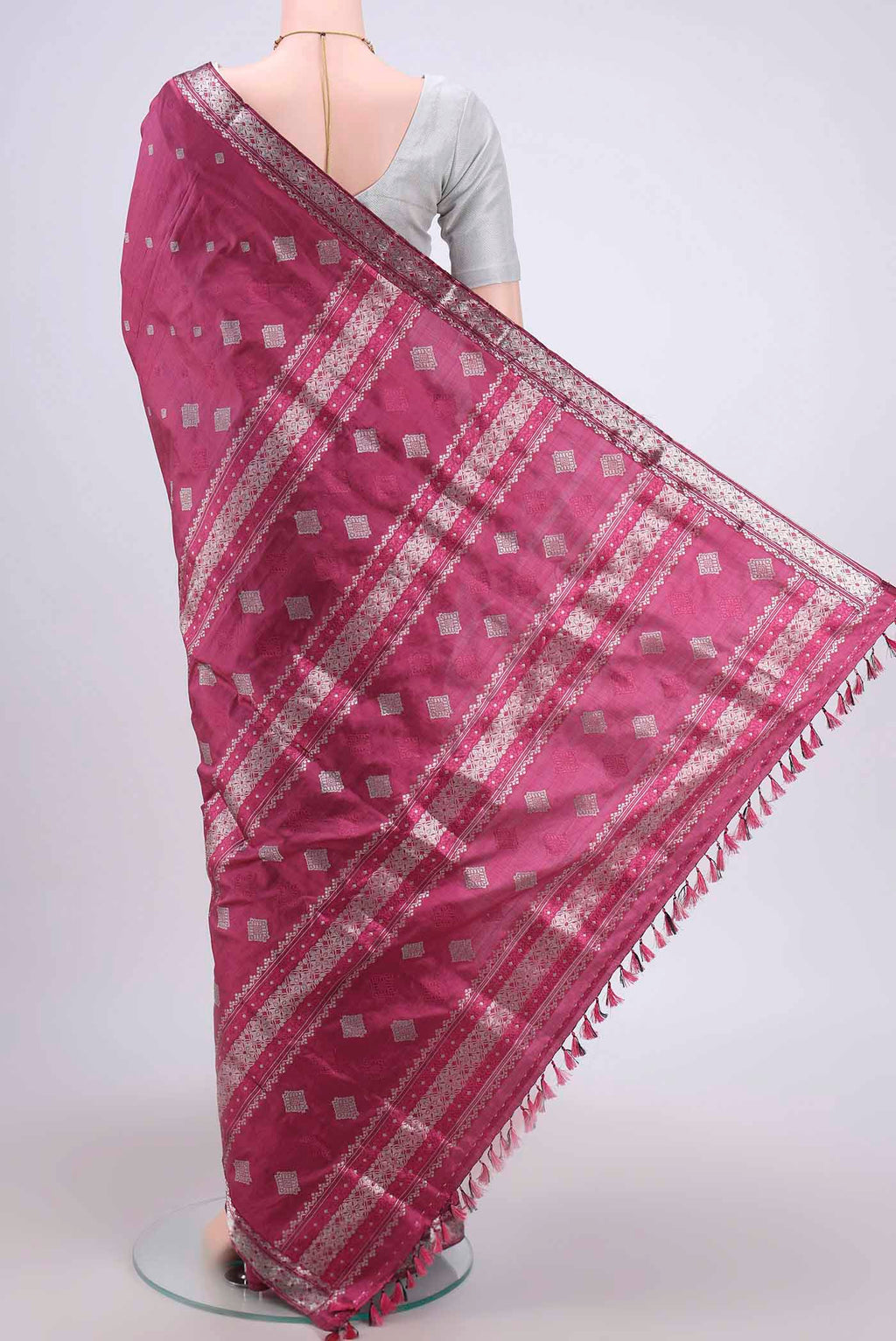 Flat view of Pink Assam Silk Saree with Zari Butta on the body and Zari Border. 