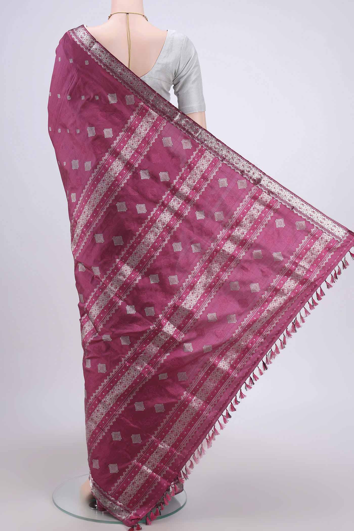 Flat view of Pink Assam Silk Saree with Zari Butta on the body and Zari Border. 