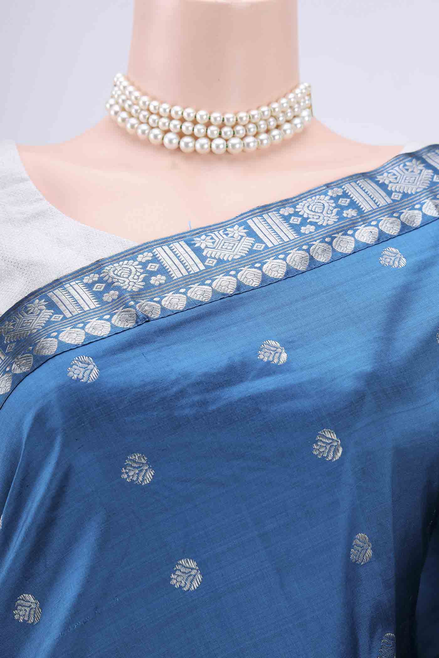 Border image of Turquoise Assam Silk Saree with Zari Butta on the body and Zari Border. 