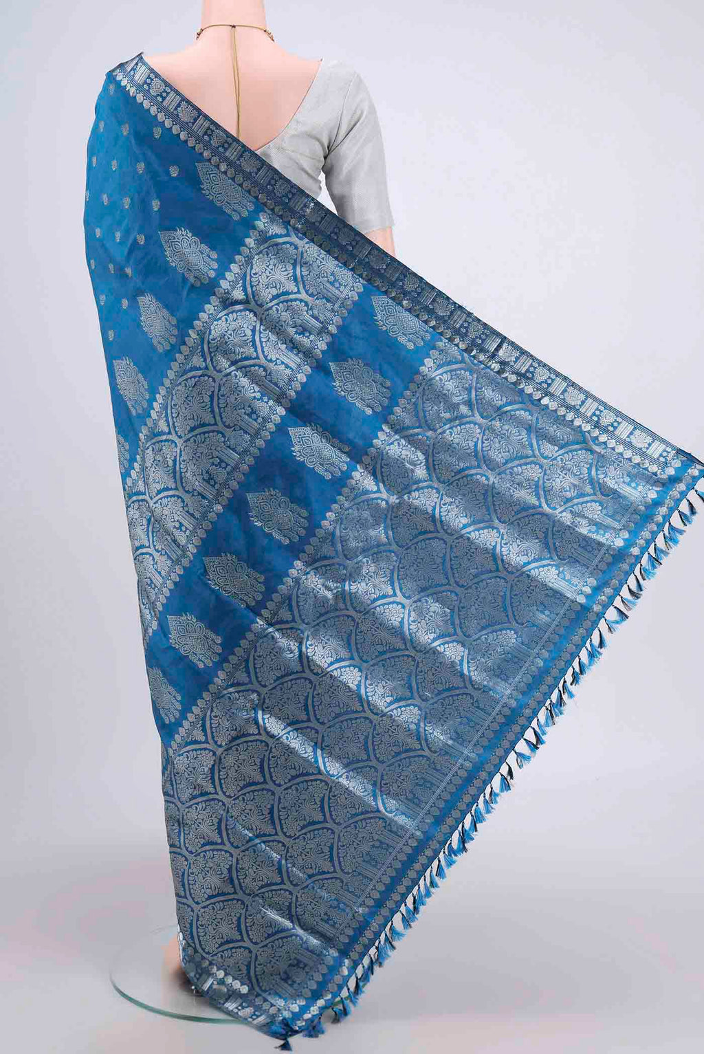 Flat view of Turquoise Assam Silk Saree with Zari Butta on the body and Zari Border. 