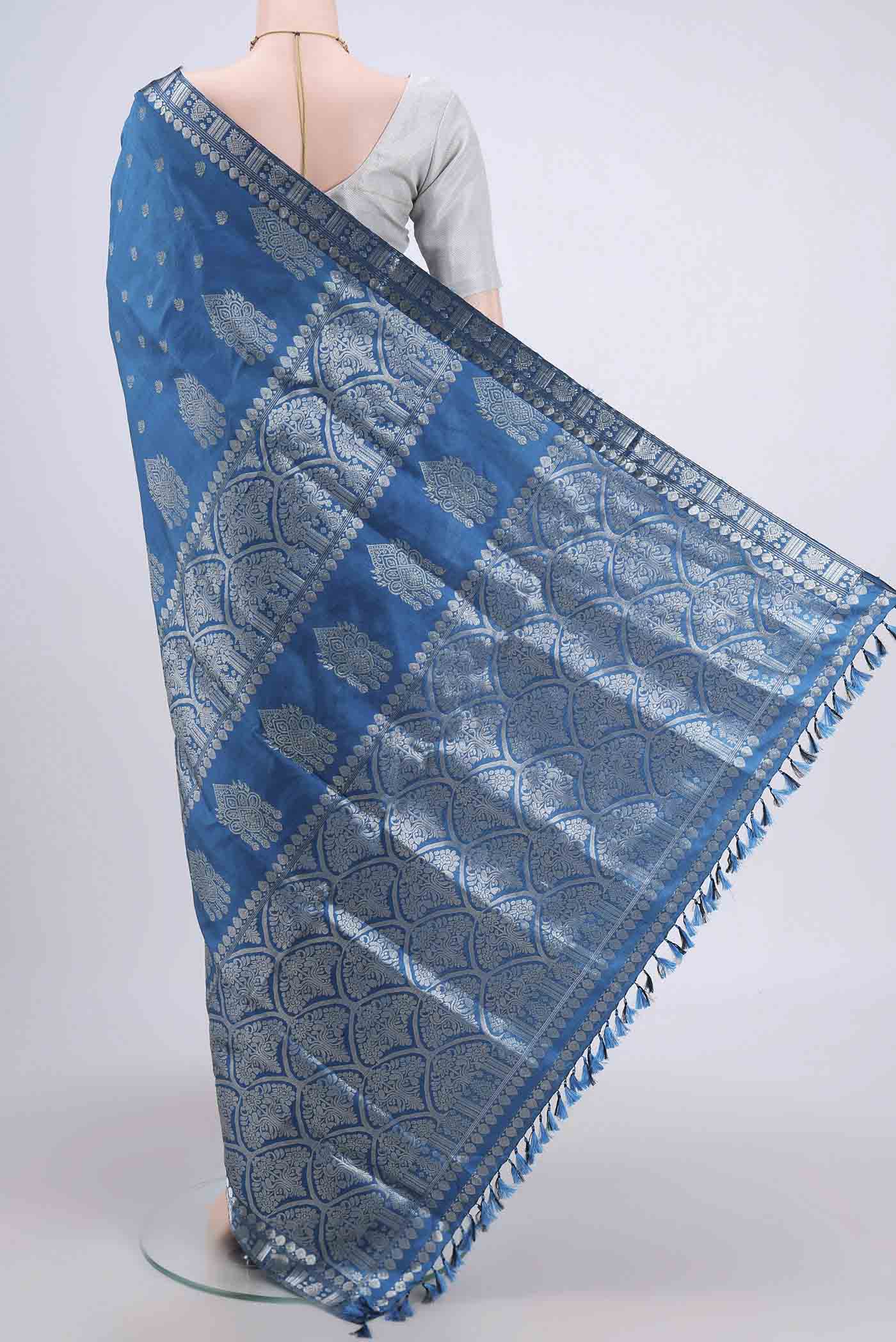 Flat view of Turquoise Assam Silk Saree with Zari Butta on the body and Zari Border. 
