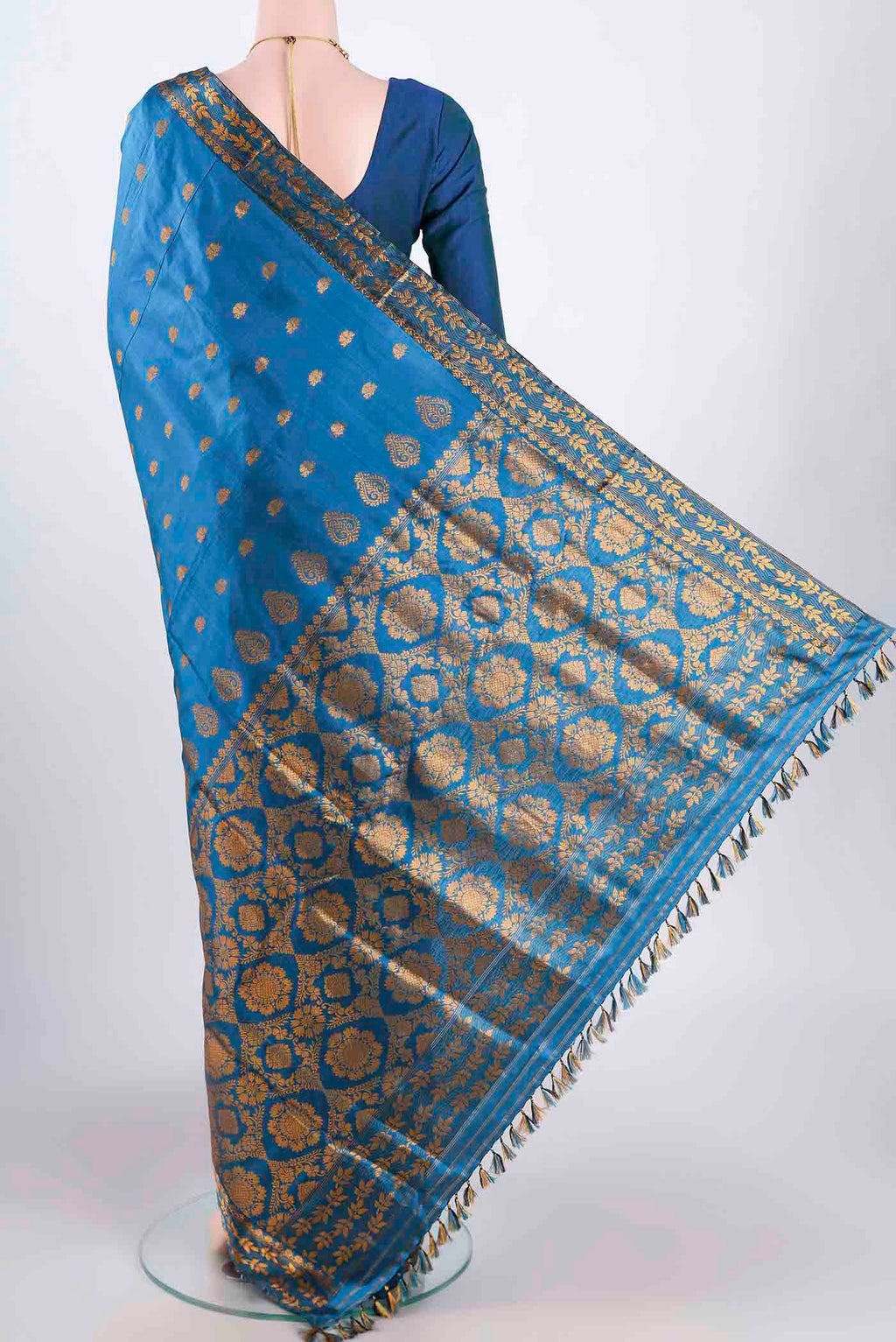 Flat view of Blue Assam Silk Saree with Zari Butta on the body and Zari Border. 