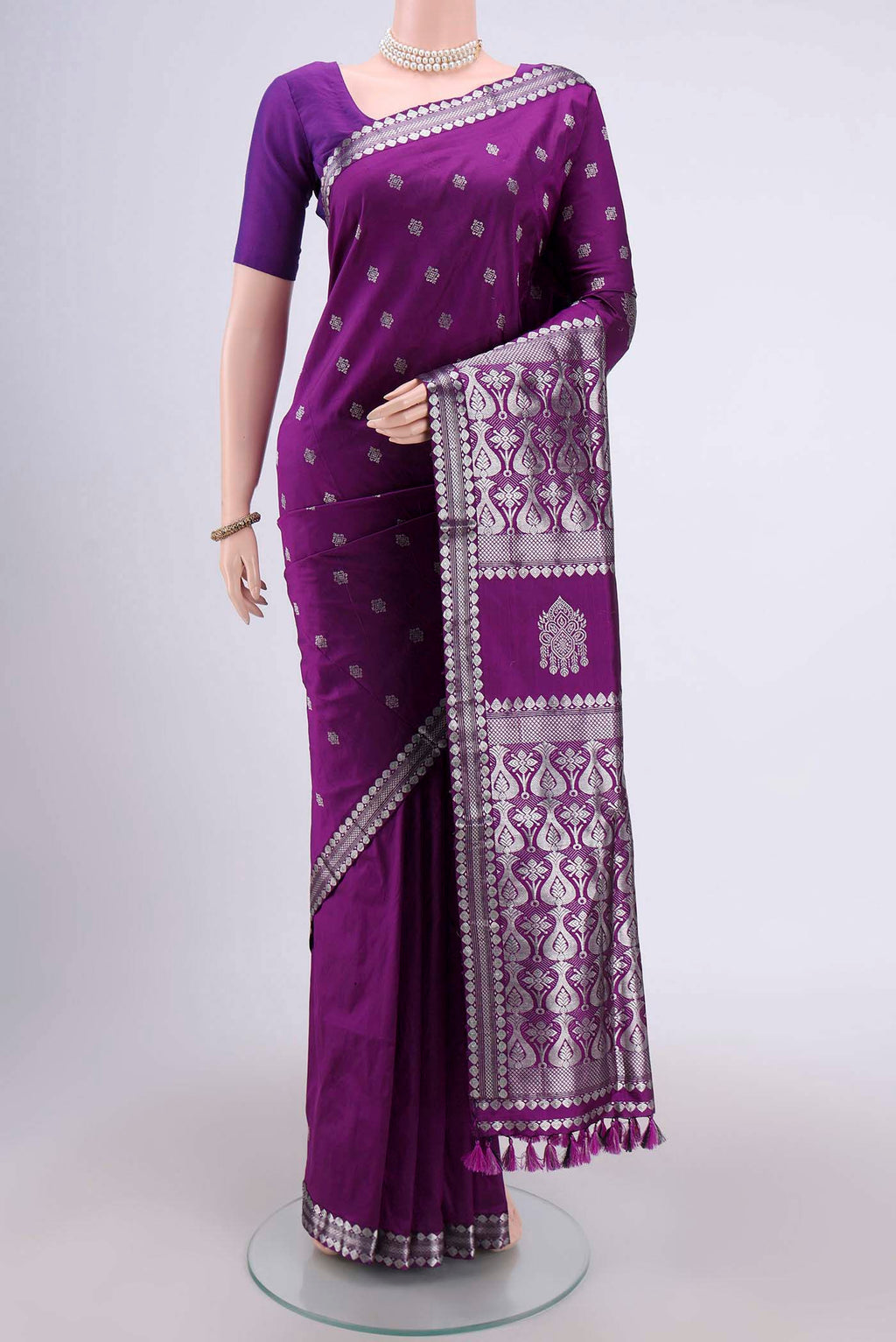 Purple Assam Silk Saree with Zari Butta on the body and Zari Border.  displayed on a mannequin