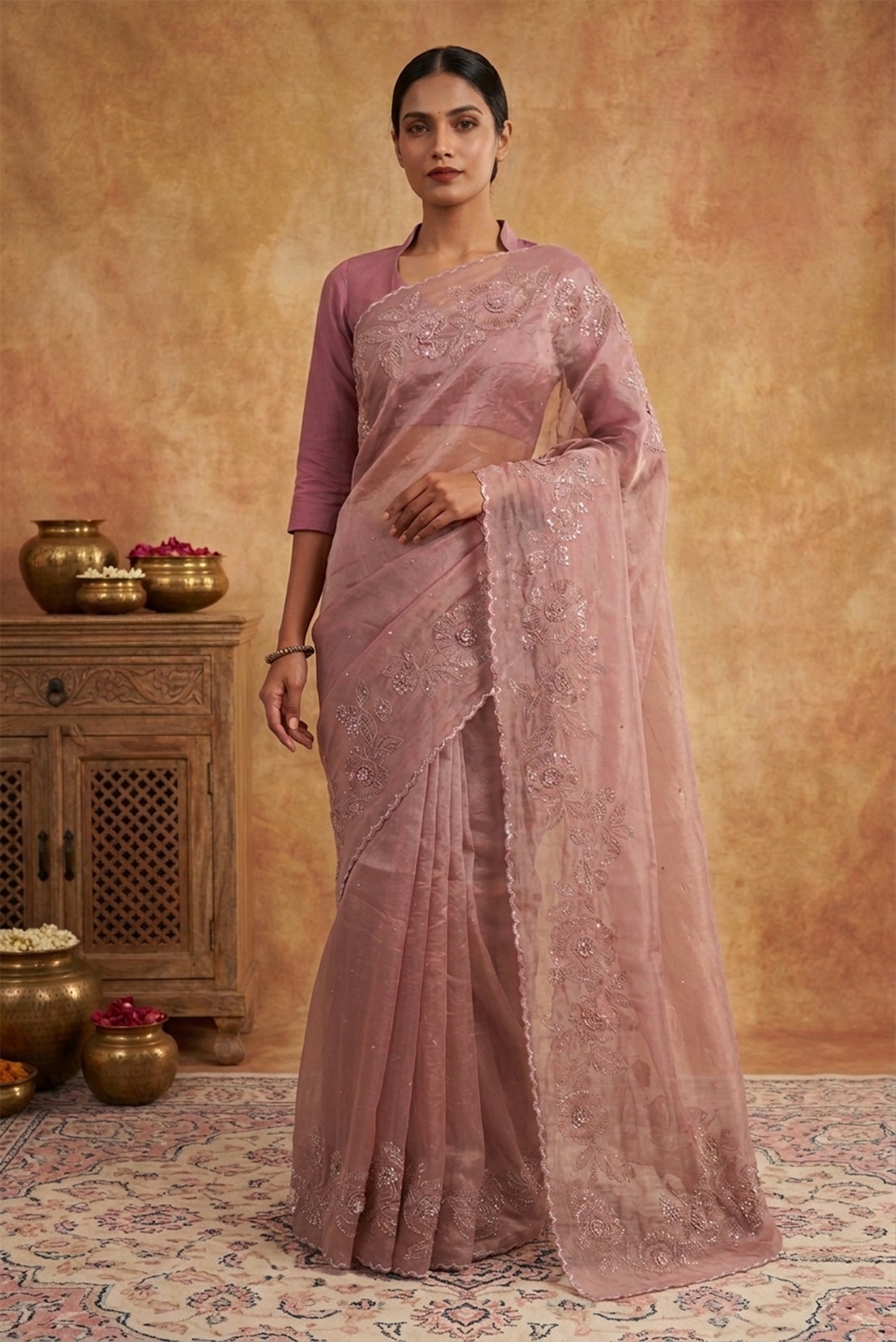Model wearing a Mauve Organza Silk Saree with Embroidery on the body and Embroidery Border.