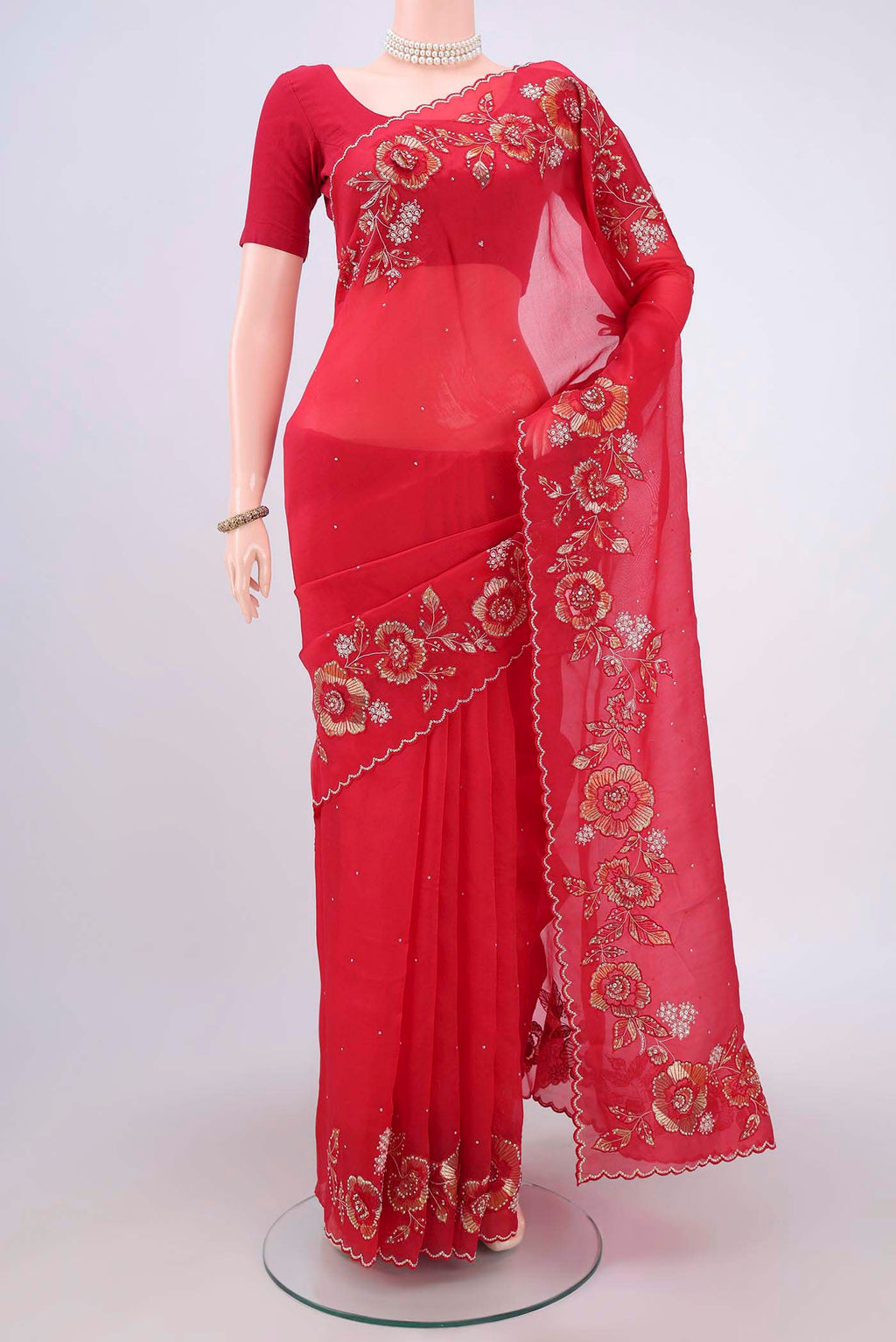 Red Organza Silk Saree with Embroidery on the body and Zari Border.  displayed on a mannequin