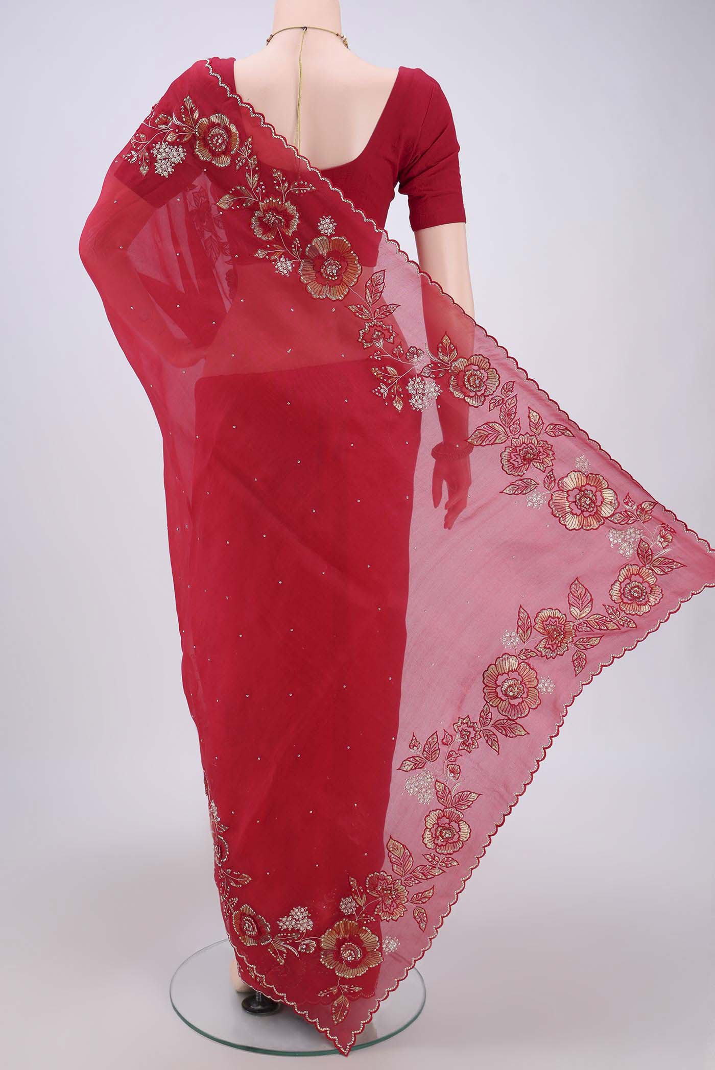 Flat view of Red Organza Silk Saree with Embroidery on the body and Zari Border. 