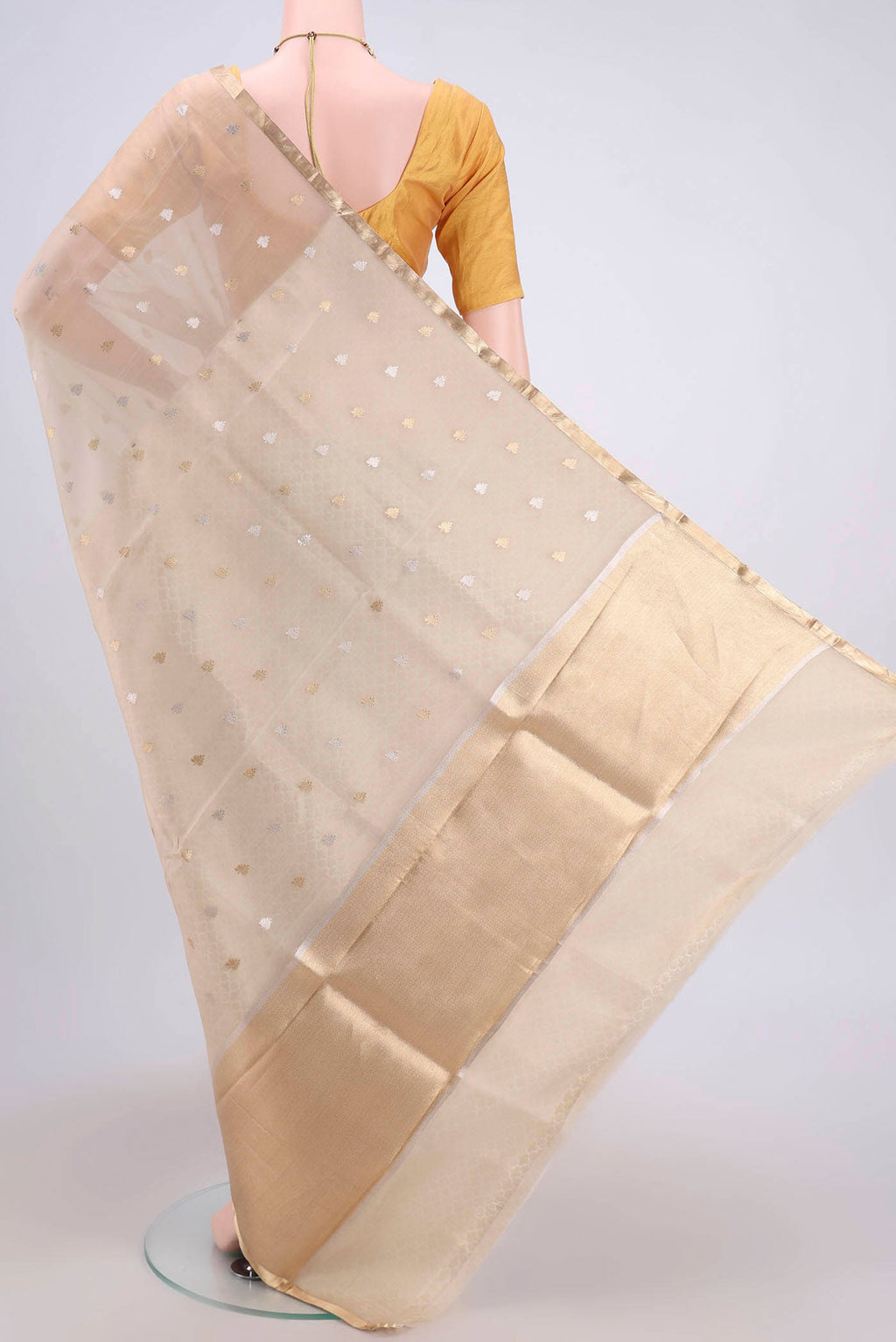 Flat view of Beige Banarasi Katan Silk Saree with Zari Butta on the body and Zari Border. 
