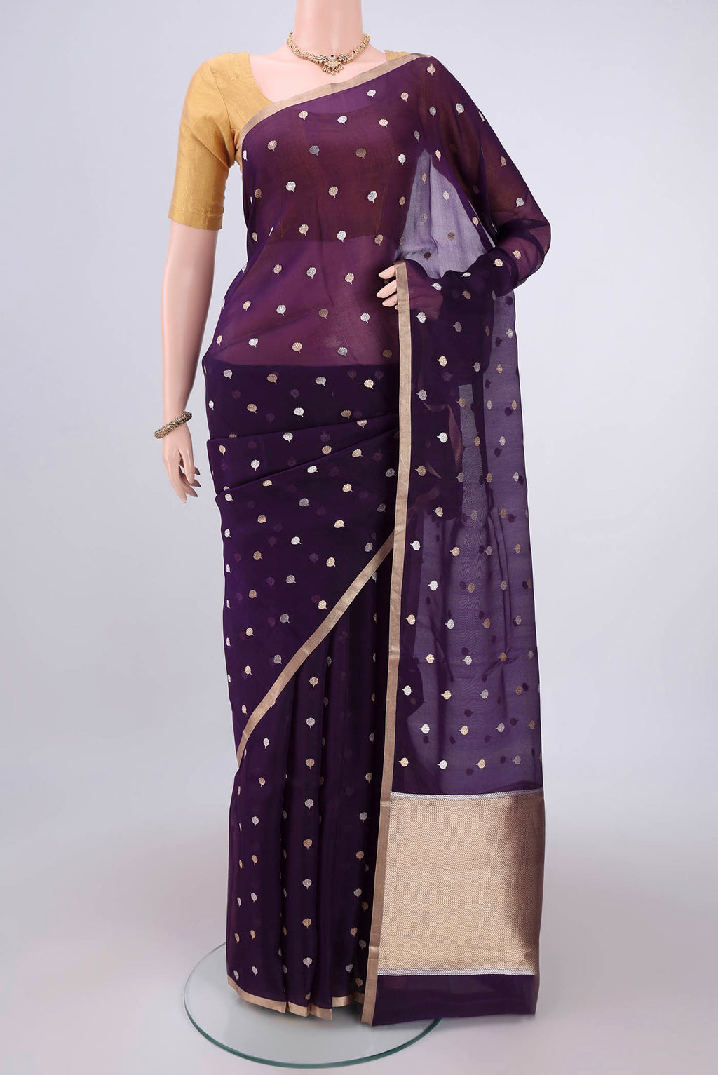Purple Organza Silk Saree with Zari Butta on the body and Thin Zari Line.  displayed on a mannequin