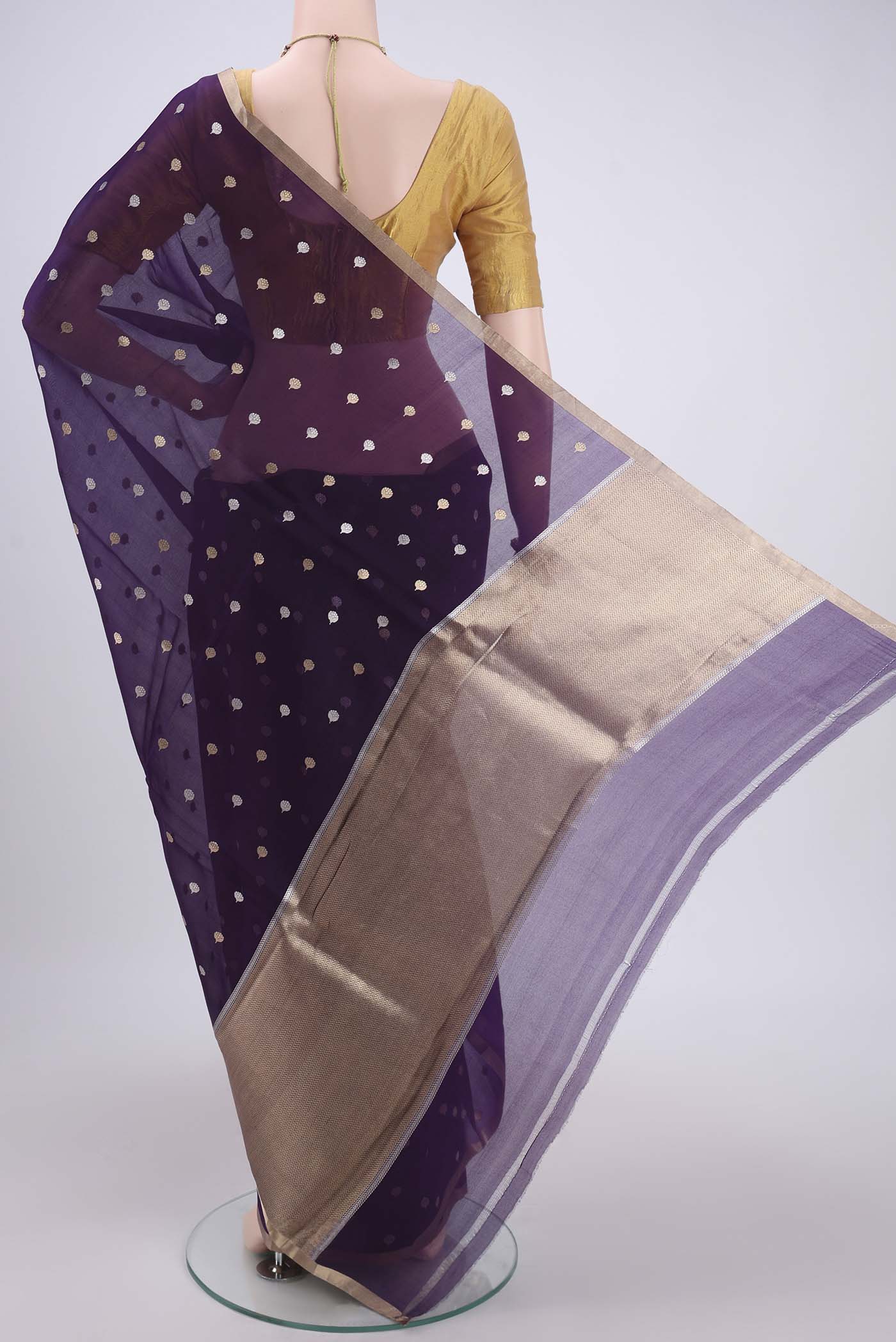 Flat view of Purple Organza Silk Saree with Zari Butta on the body and Thin Zari Line. 