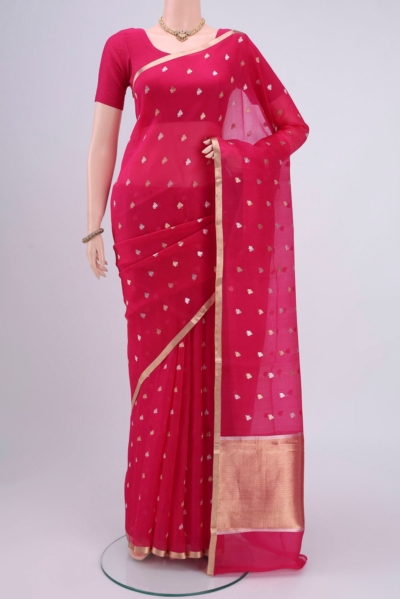 Dark Pink Organza Silk Saree with Zari Butta on the body and Zari Border.  displayed on a mannequin