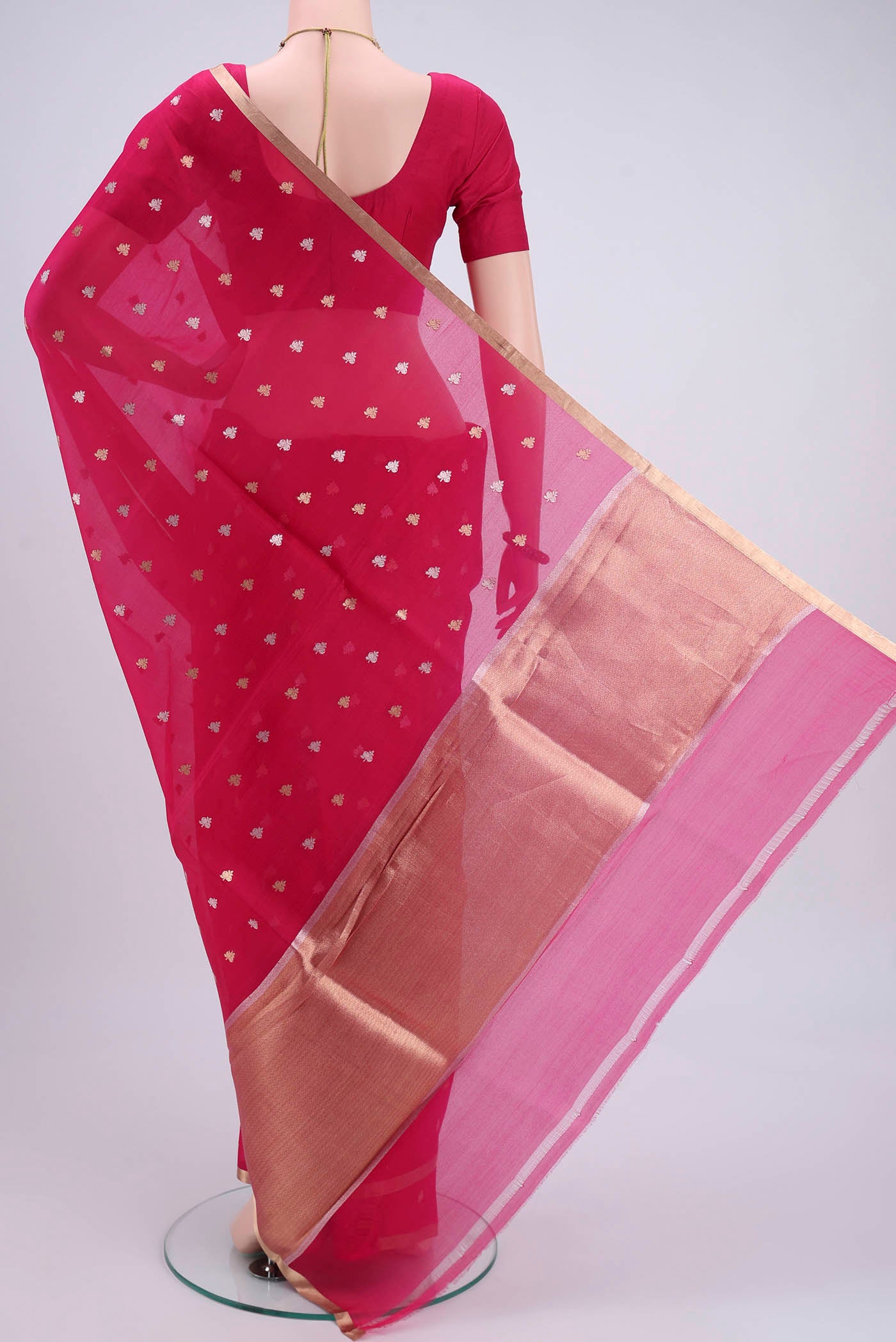 Flat view of Dark Pink Organza Silk Saree with Zari Butta on the body and Zari Border. 