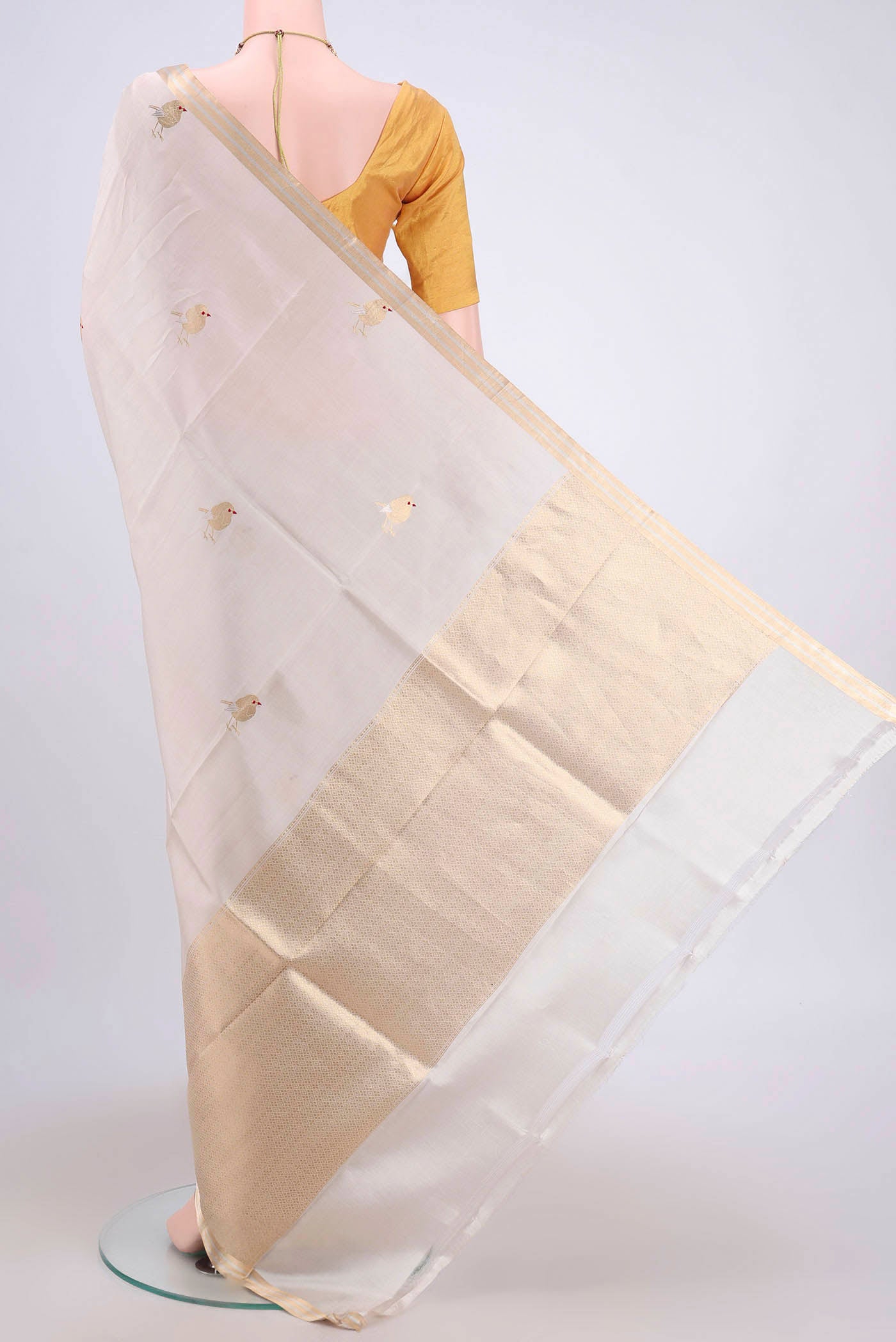 Flat view of Cream Banarasi Katan Silk Saree with Zari Butta on the body and Zari Border. 