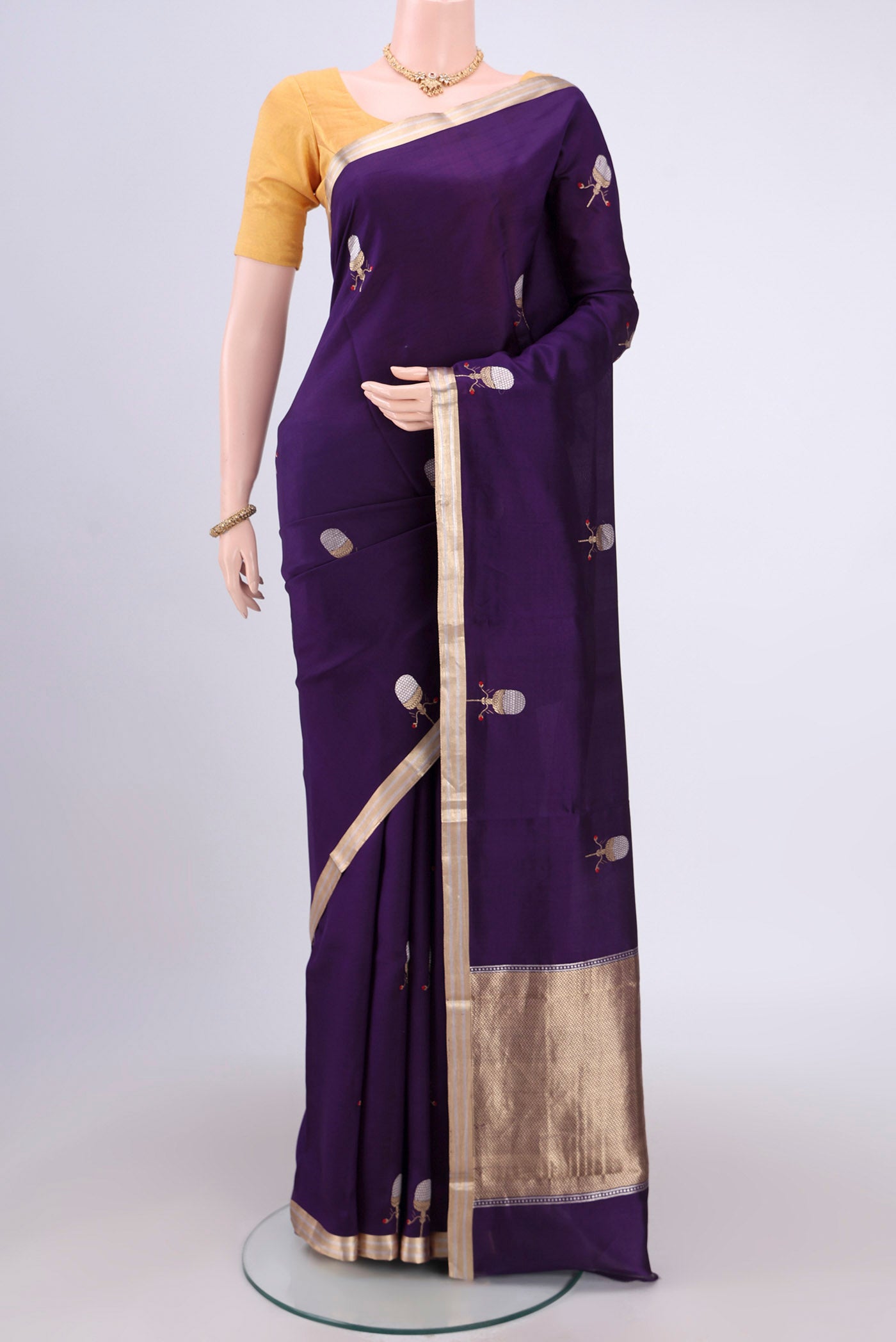 Purple Banarasi Katan Silk Saree with Zari Butta on the body and Thin Zari Line.  displayed on a mannequin