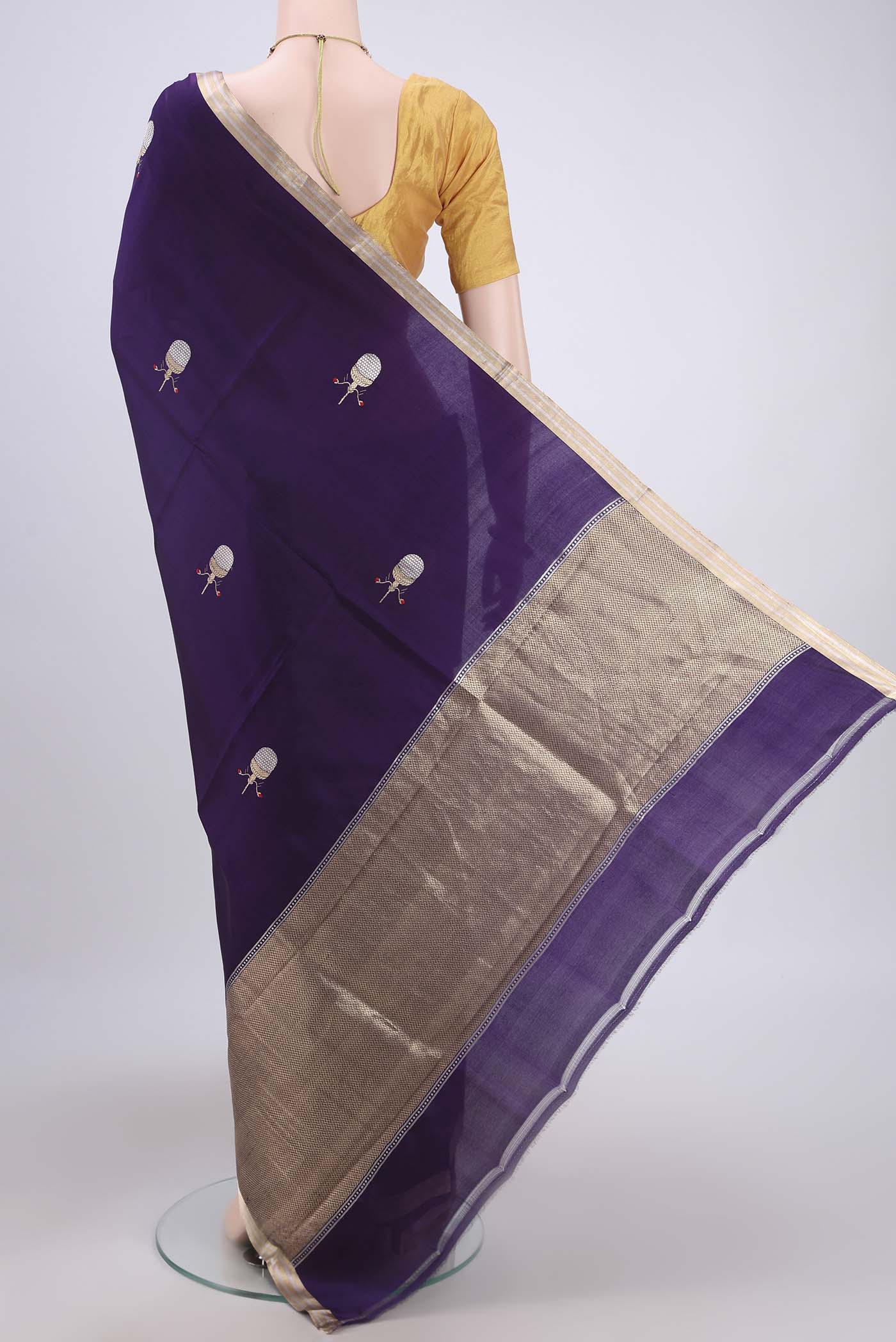 Flat view of Purple Banarasi Katan Silk Saree with Zari Butta on the body and Thin Zari Line. 