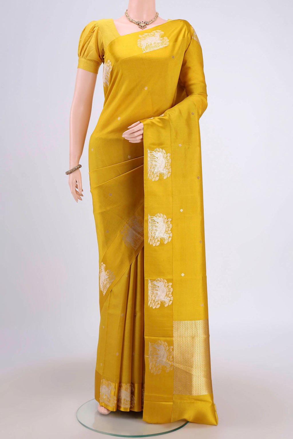 Yellow Banarasi Katan Silk Saree with Zari Butta on the body and Zari Border.  displayed on a mannequin