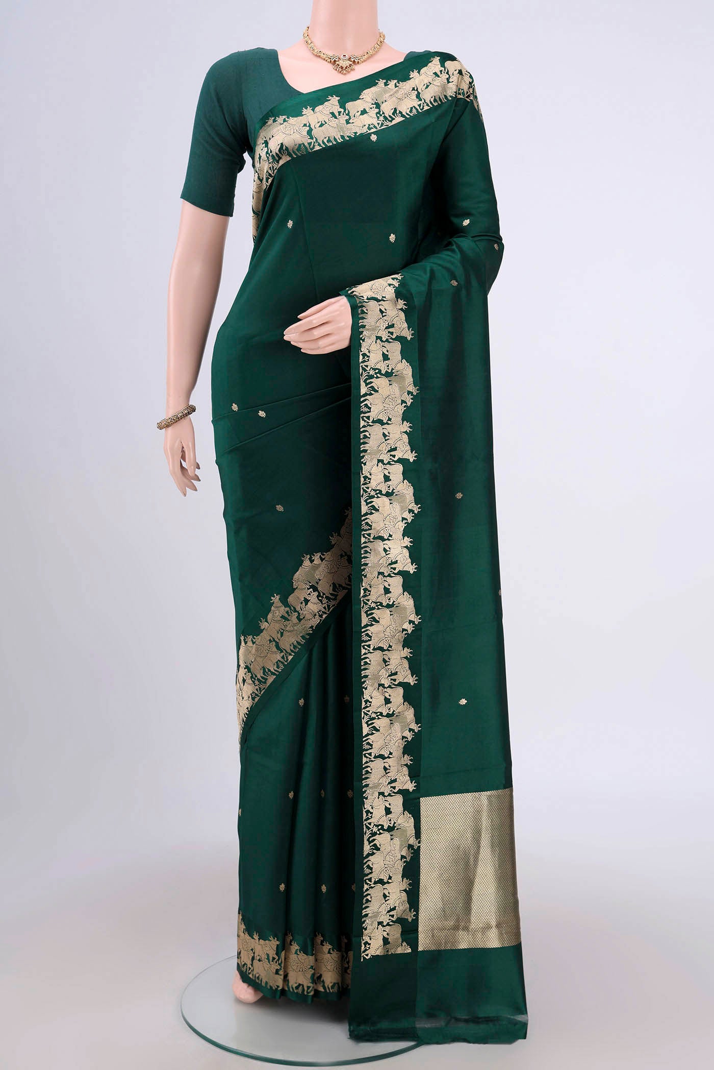 Bottle Green Banarasi Katan Silk Saree with Stripes on the body and Zari Border.  displayed on a mannequin