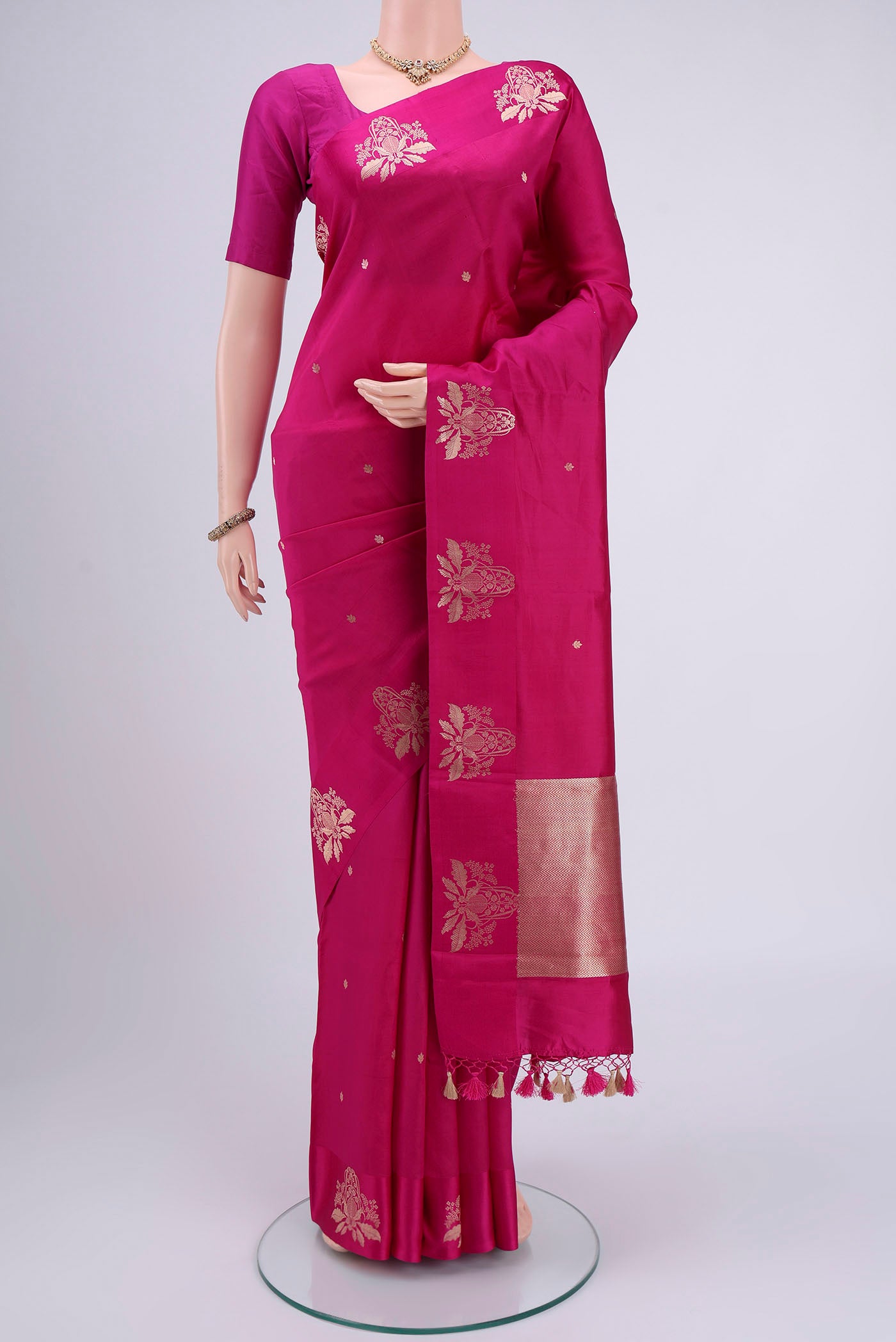 Rani Pink Banarasi Katan Silk Saree with Zari Butta on the body and Thin Zari Line.  displayed on a mannequin