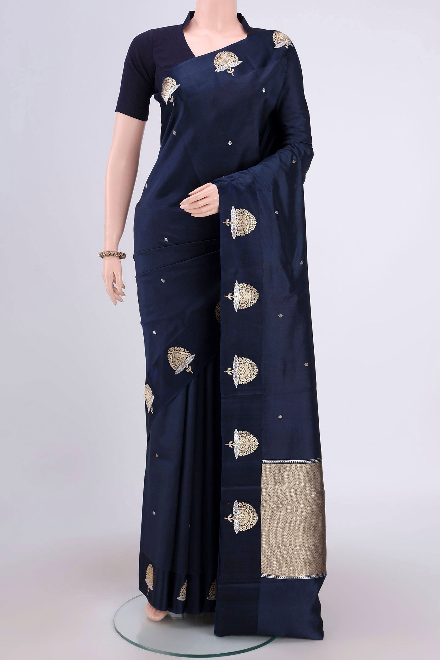 Navy Blue Banarasi Katan Silk Saree with Zari Butta on the body and Zari Border.  displayed on a mannequin