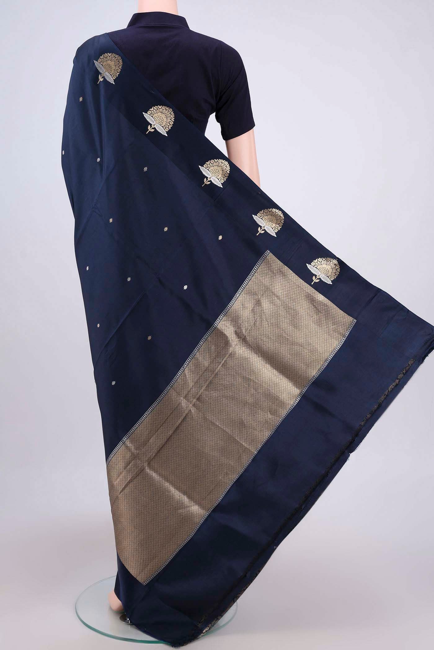 Flat view of Navy Blue Banarasi Katan Silk Saree with Zari Butta on the body and Zari Border. 