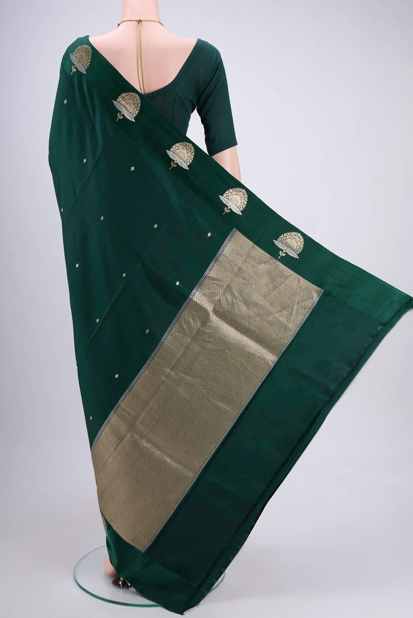 Flat view of Green Banarasi Silk Saree with Zari Butta on the body and Zari Border. 