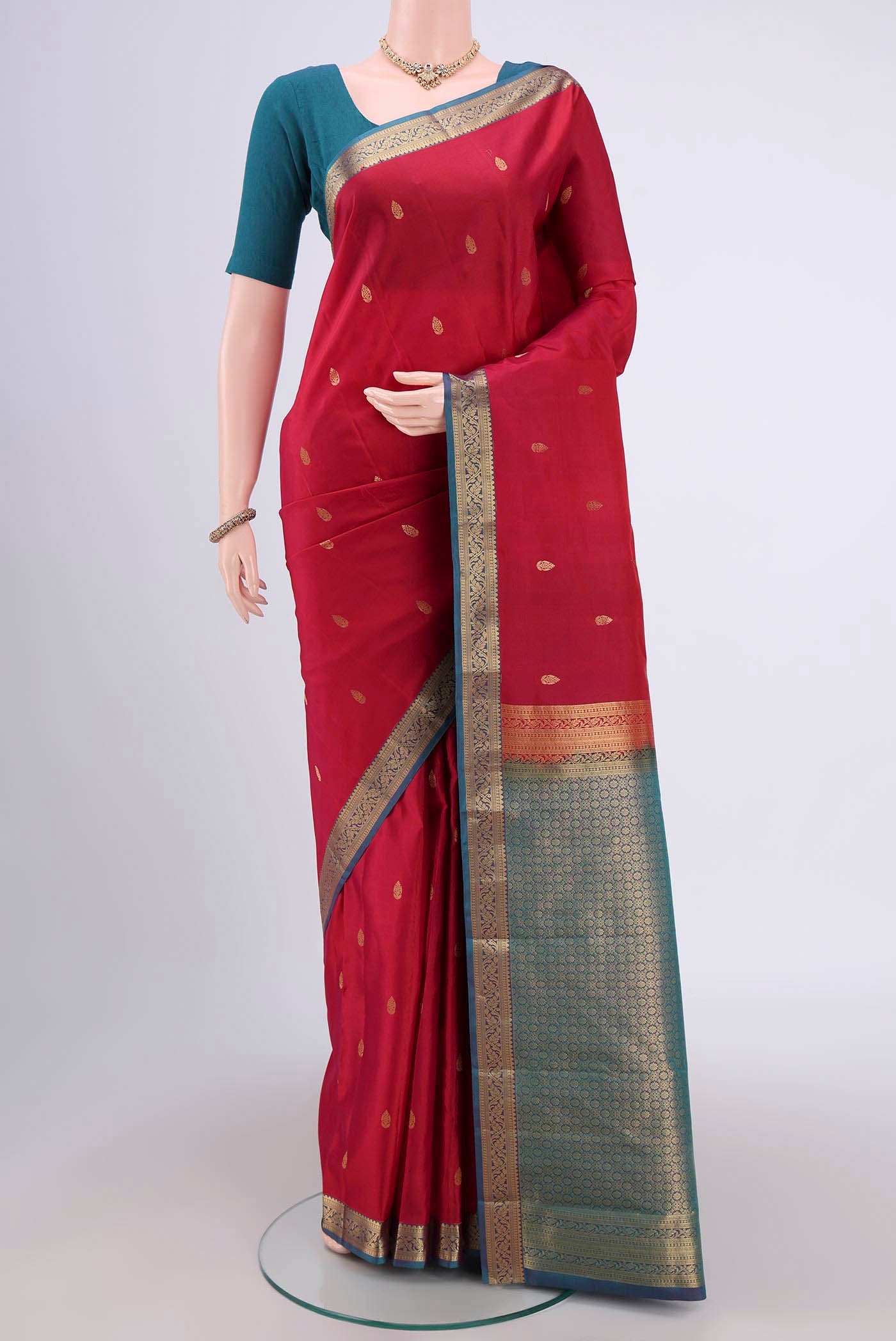 Maroon Dual Tone Kanjivaram Saree with Zari Butta on the body and Zari Border.  displayed on a mannequin