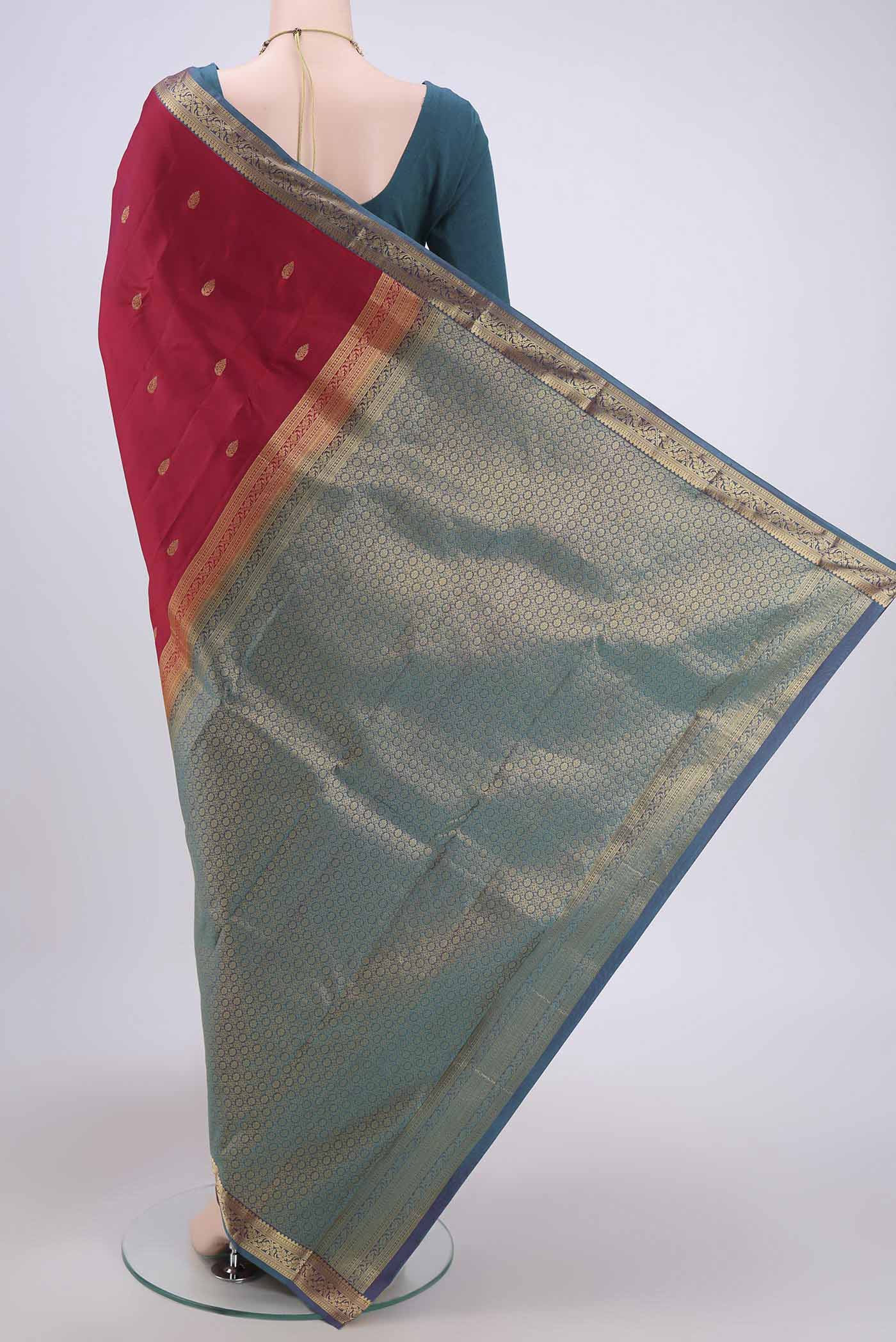 Flat view of Maroon Dual Tone Kanjivaram Saree with Zari Butta on the body and Zari Border. 