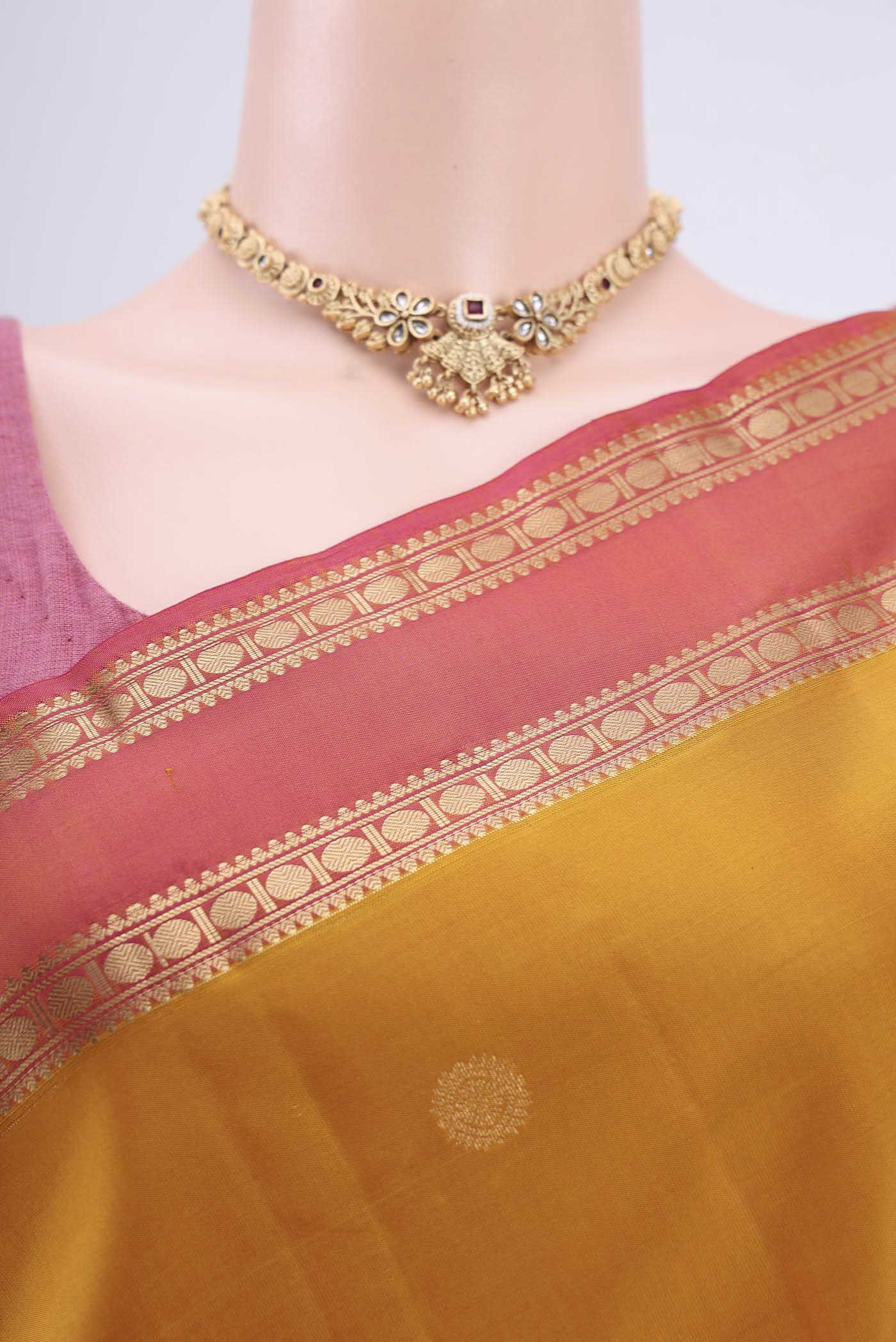 Border image of Mustard Kanchipuram Saree with Zari Butta on the body and Zari Border. 
