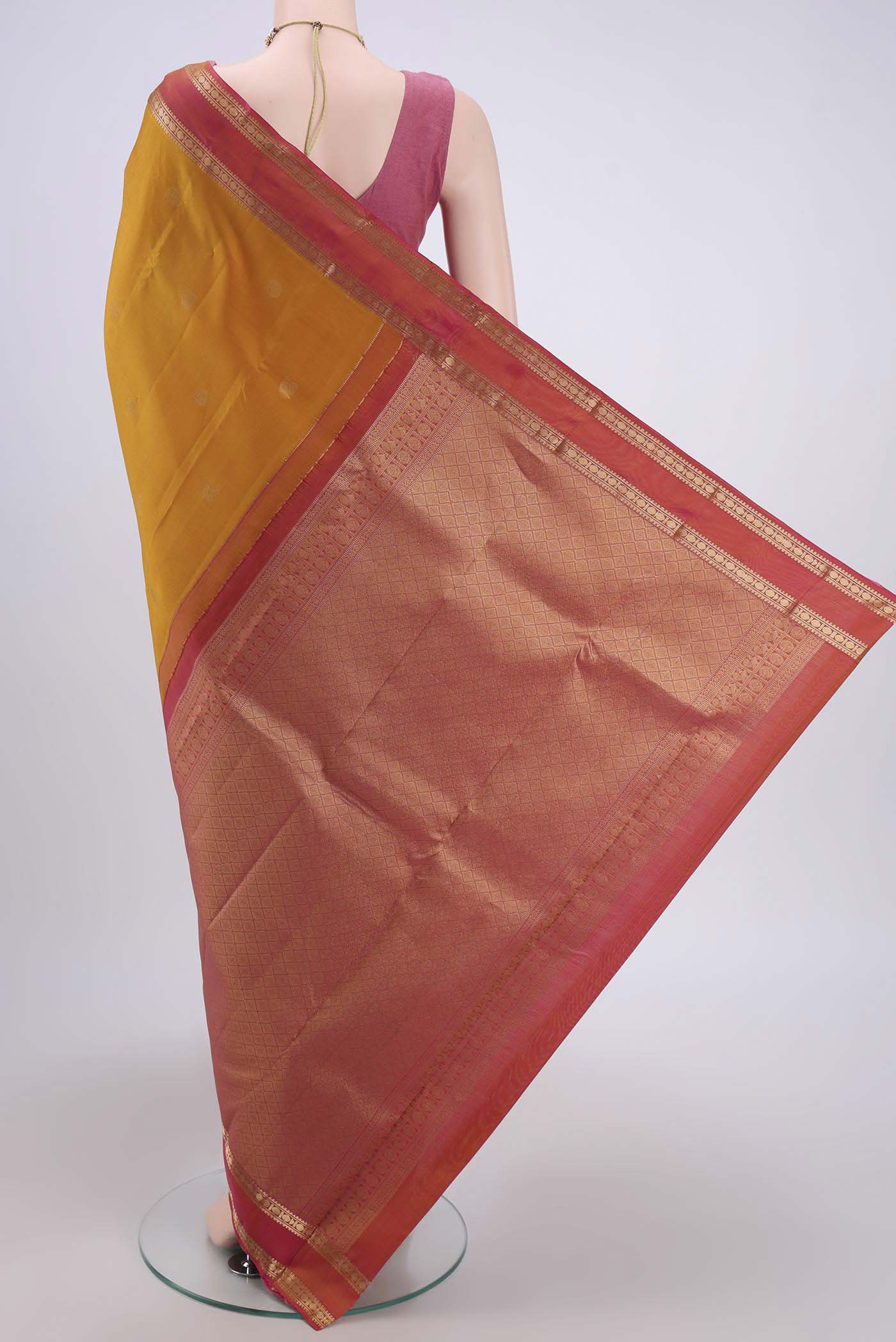 Flat view of Mustard Kanchipuram Saree with Zari Butta on the body and Zari Border. 