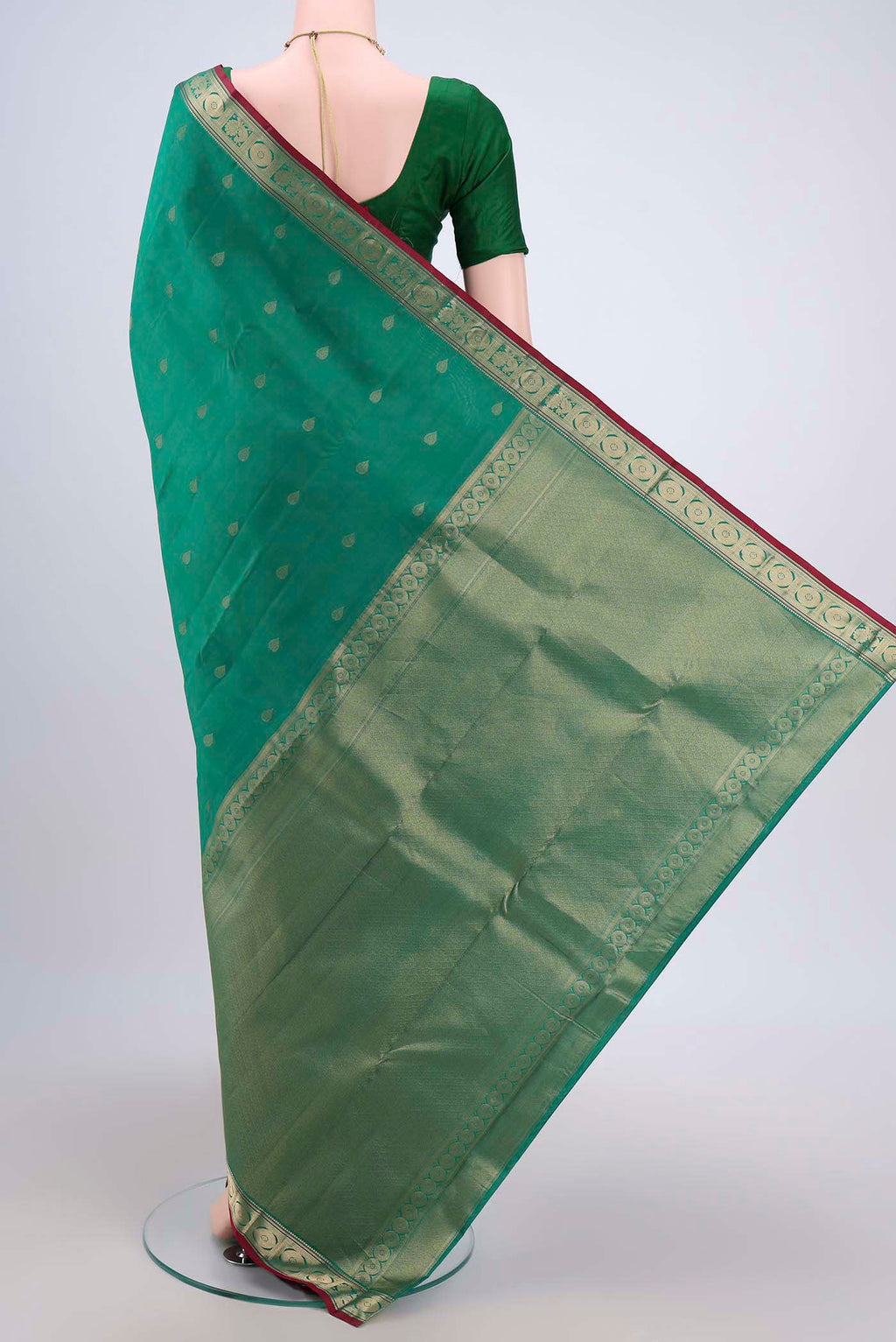 Flat view of Green Dual Tone Kanchipuram Saree with Zari Butta on the body and Zari Border. 