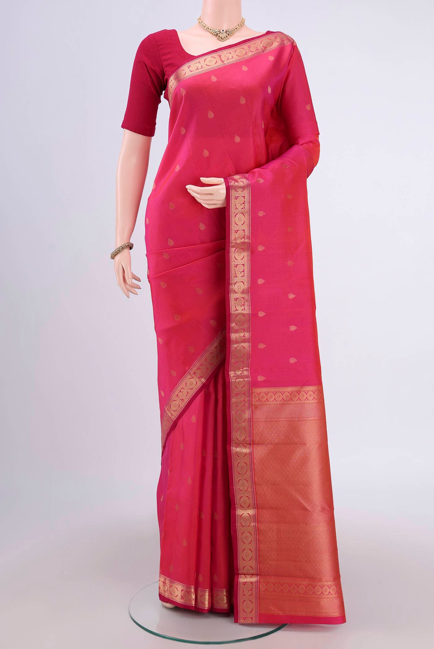 Dark Pink Dual Tone Kanchipuram Saree with Zari Butta on the body and Zari Border.  displayed on a mannequin