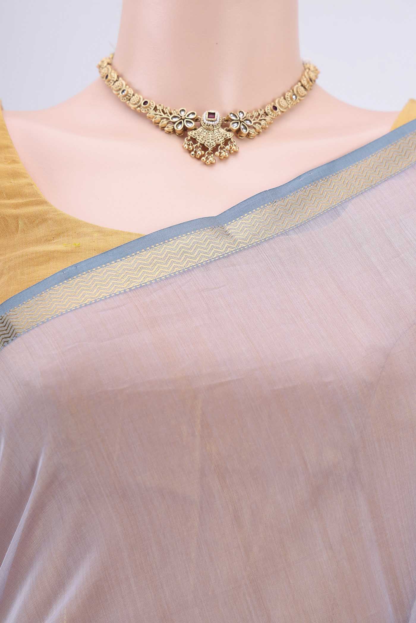 Border image of Lavender Maheshwari Silk Cotton Saree with Stripes on the body and Zari Border. 