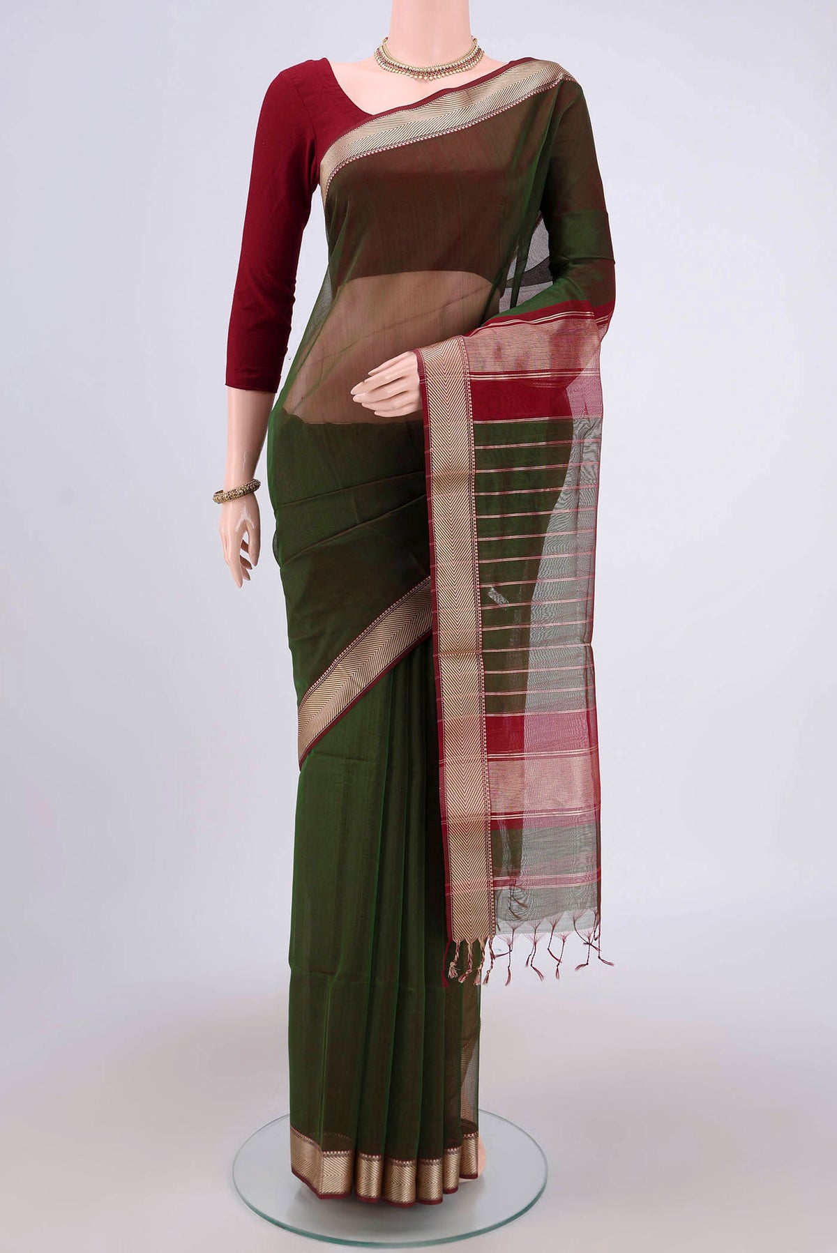Green Maheshwari Silk Cotton Saree with Plain Body and Zari Border.  displayed on a mannequin