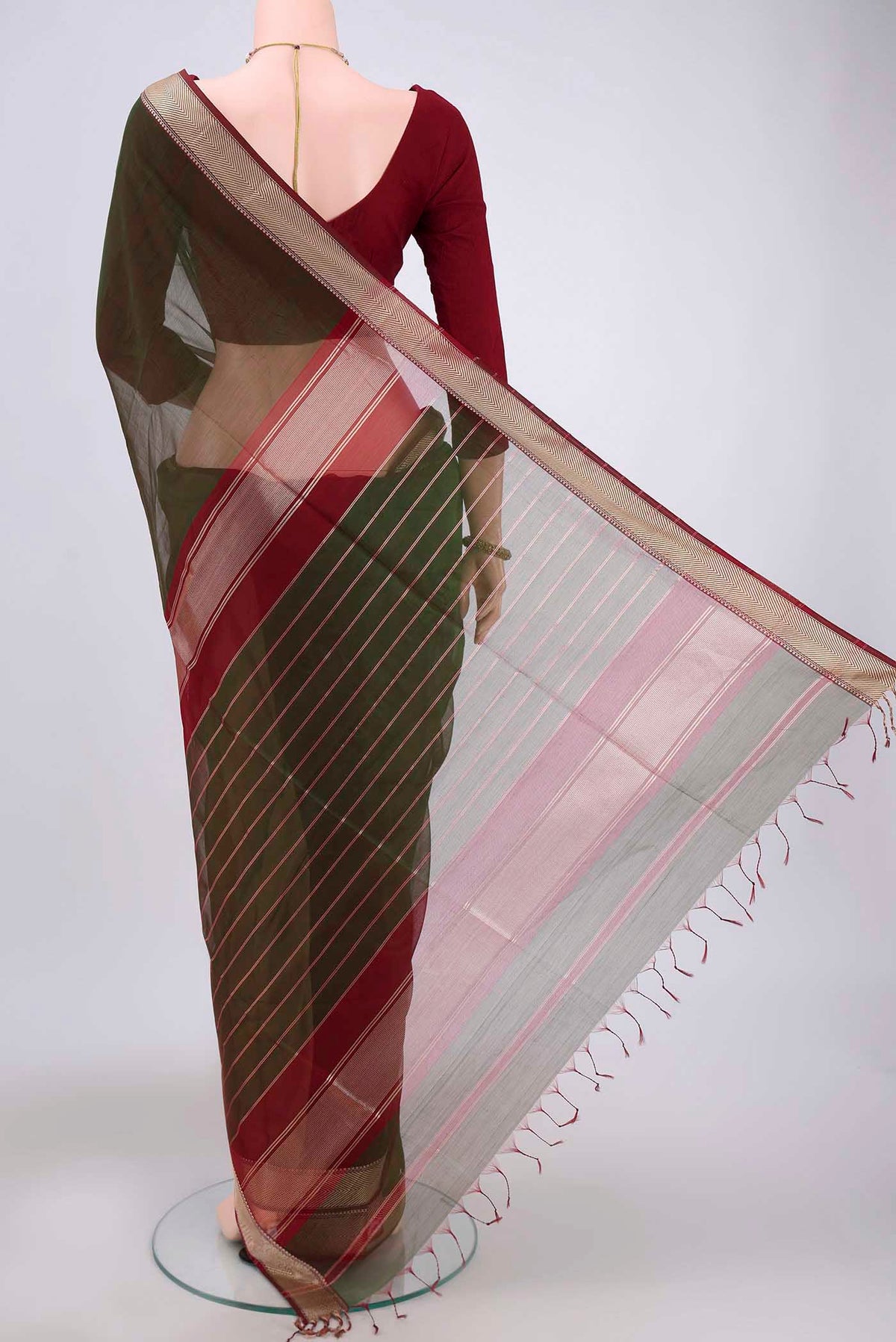Flat view of Green Maheshwari Silk Cotton Saree with Plain Body and Zari Border. 