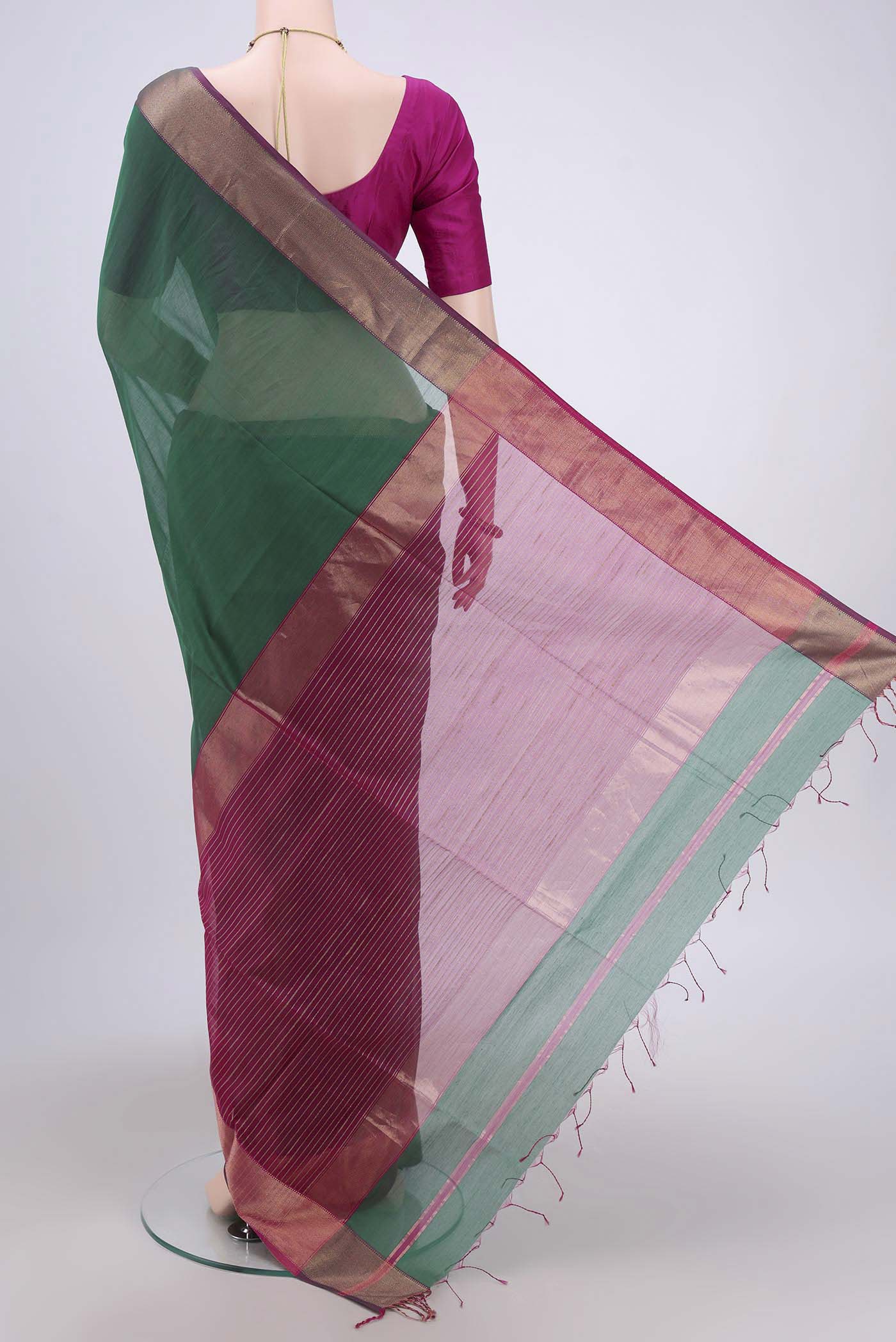 Flat view of Bottle Green Maheshwari Silk Cotton Saree with Zari And Thread Butta on the body and Zari Border. 