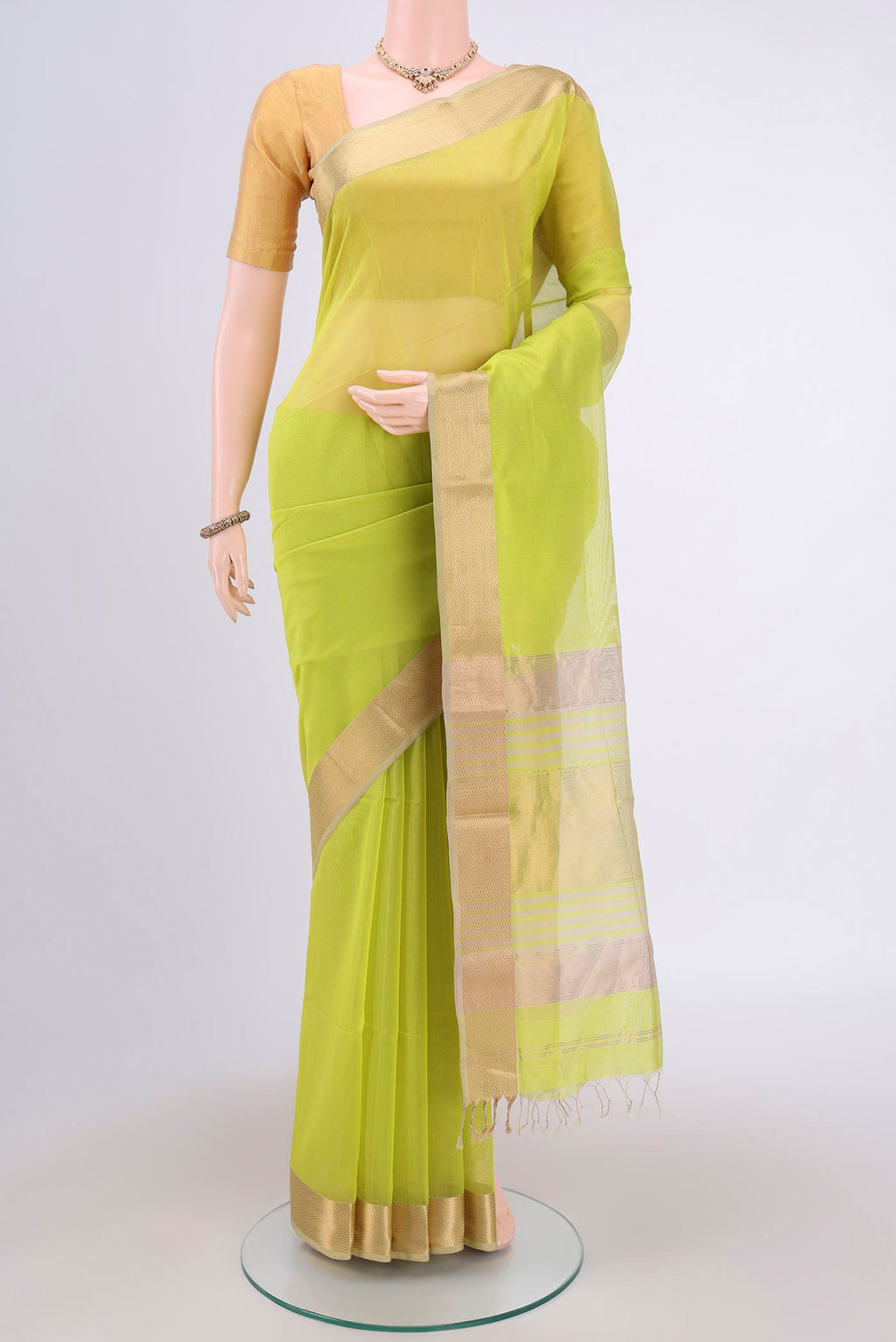 Parrot Green Maheshwari Silk Cotton Saree with Plain Body and Zari Border.  displayed on a mannequin