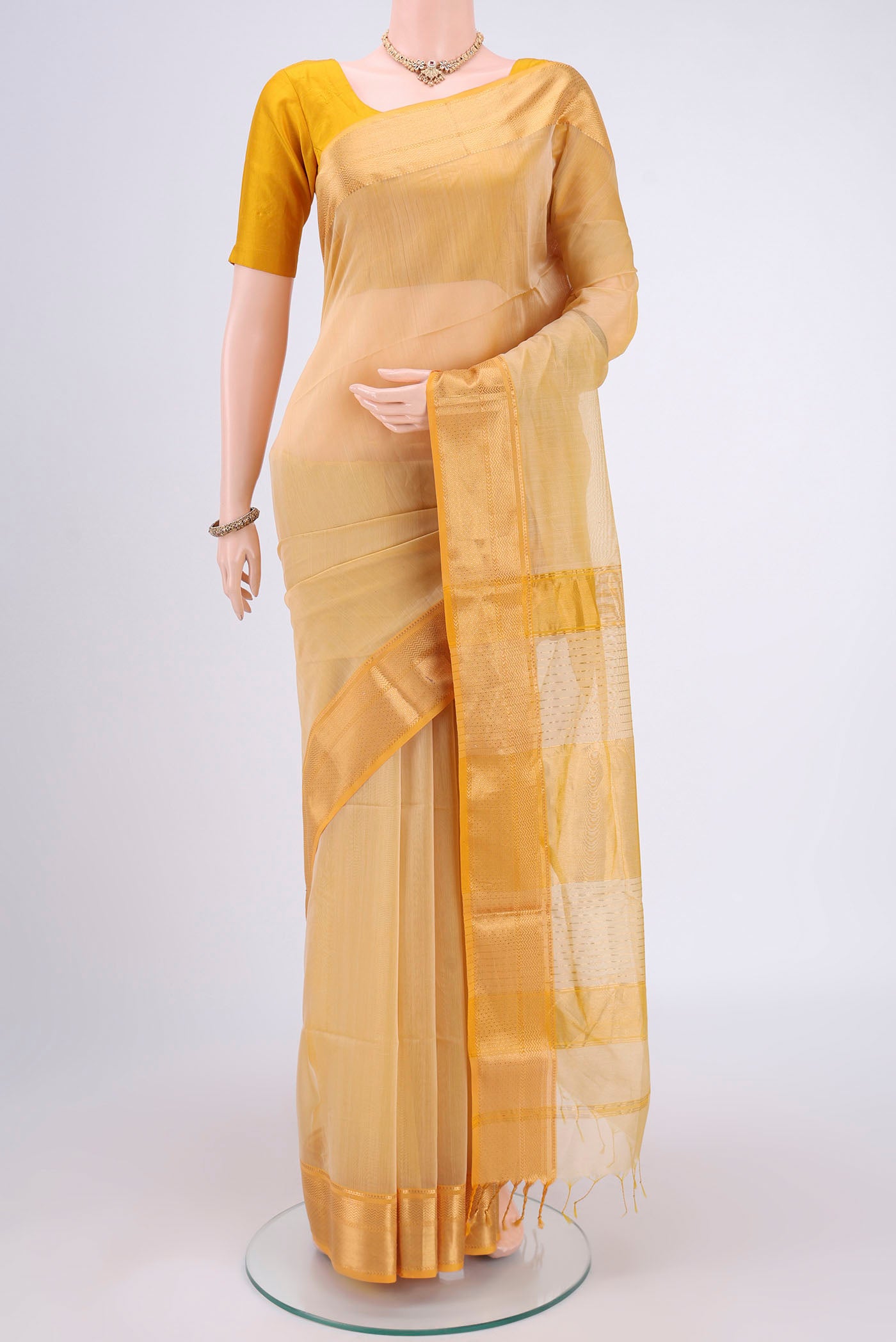 Cream Dual Tone Maheshwari Silk Cotton Saree with Plain Body and Zari Border.  displayed on a mannequin