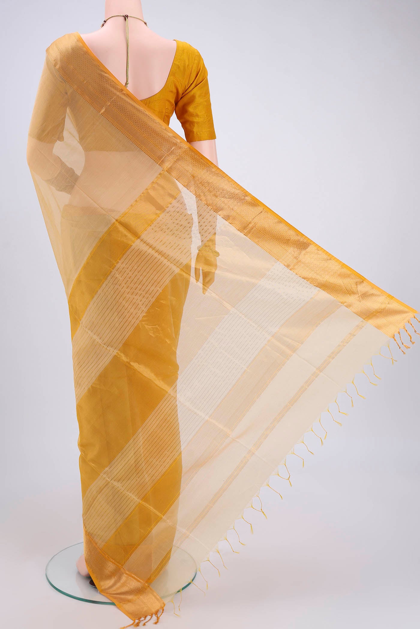 Flat view of Cream Dual Tone Maheshwari Silk Cotton Saree with Plain Body and Zari Border. 