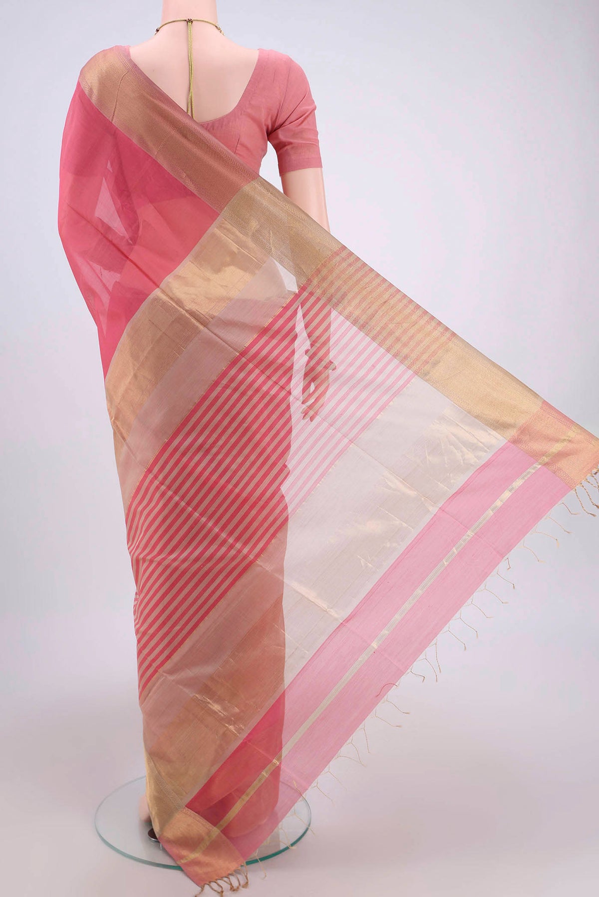 Flat view of Peach Maheshwari Silk Cotton Saree with Plain Body and Zari Border. 