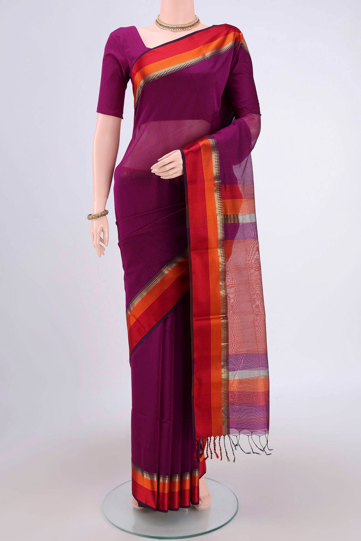 Magenta Maheshwari Silk Cotton Saree with Plain Body and Zari Border.  displayed on a mannequin