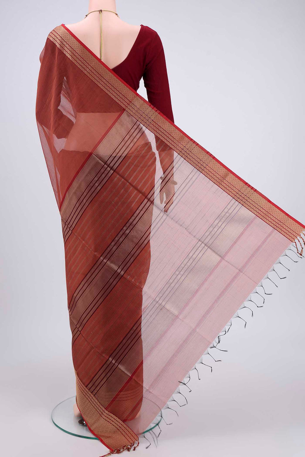 Flat view of Brown Maheshwari Silk Cotton Saree with Plain Body and Zari Border. 