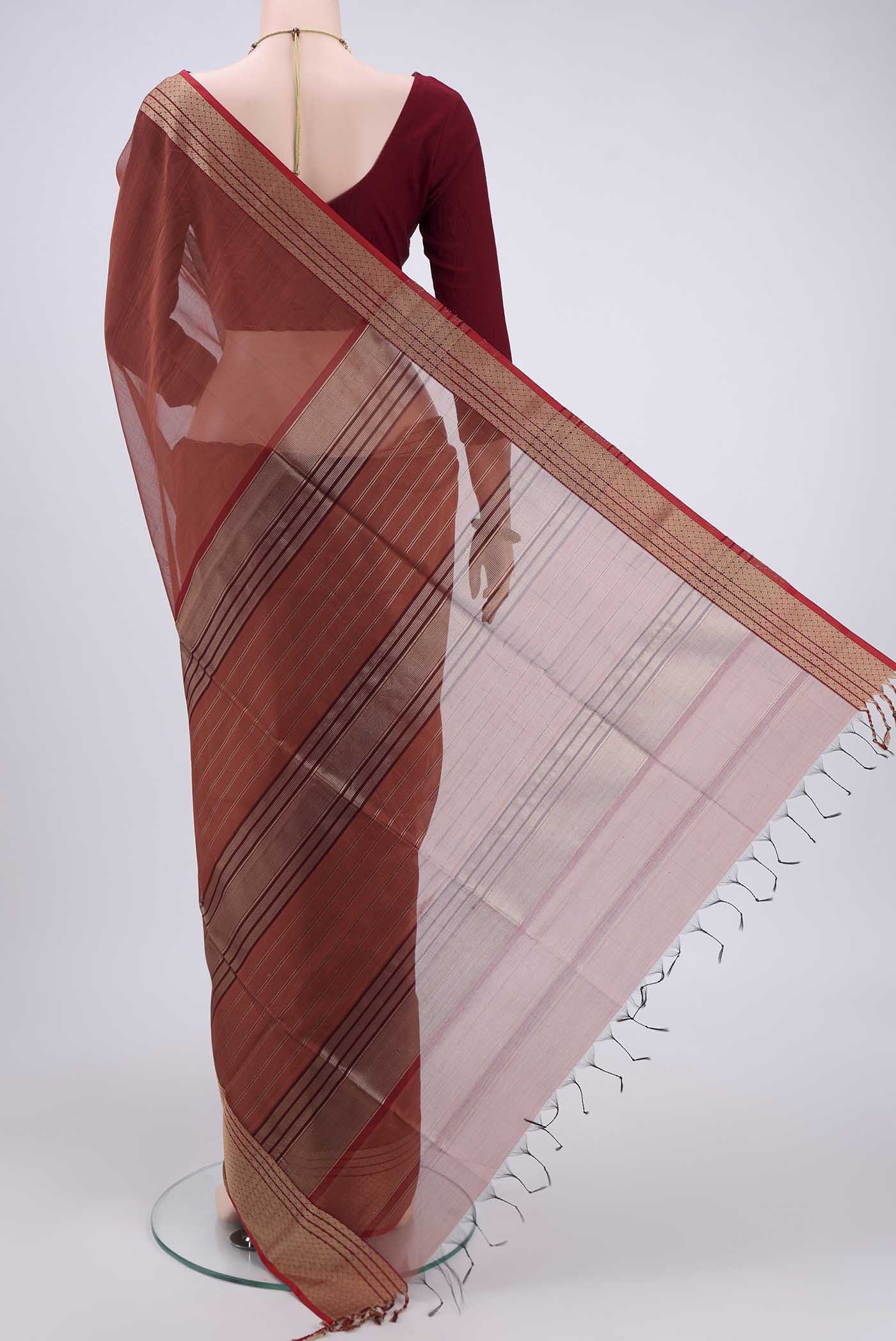 Flat view of Brown Maheshwari Silk Cotton Saree with Plain Body and Zari Border. 