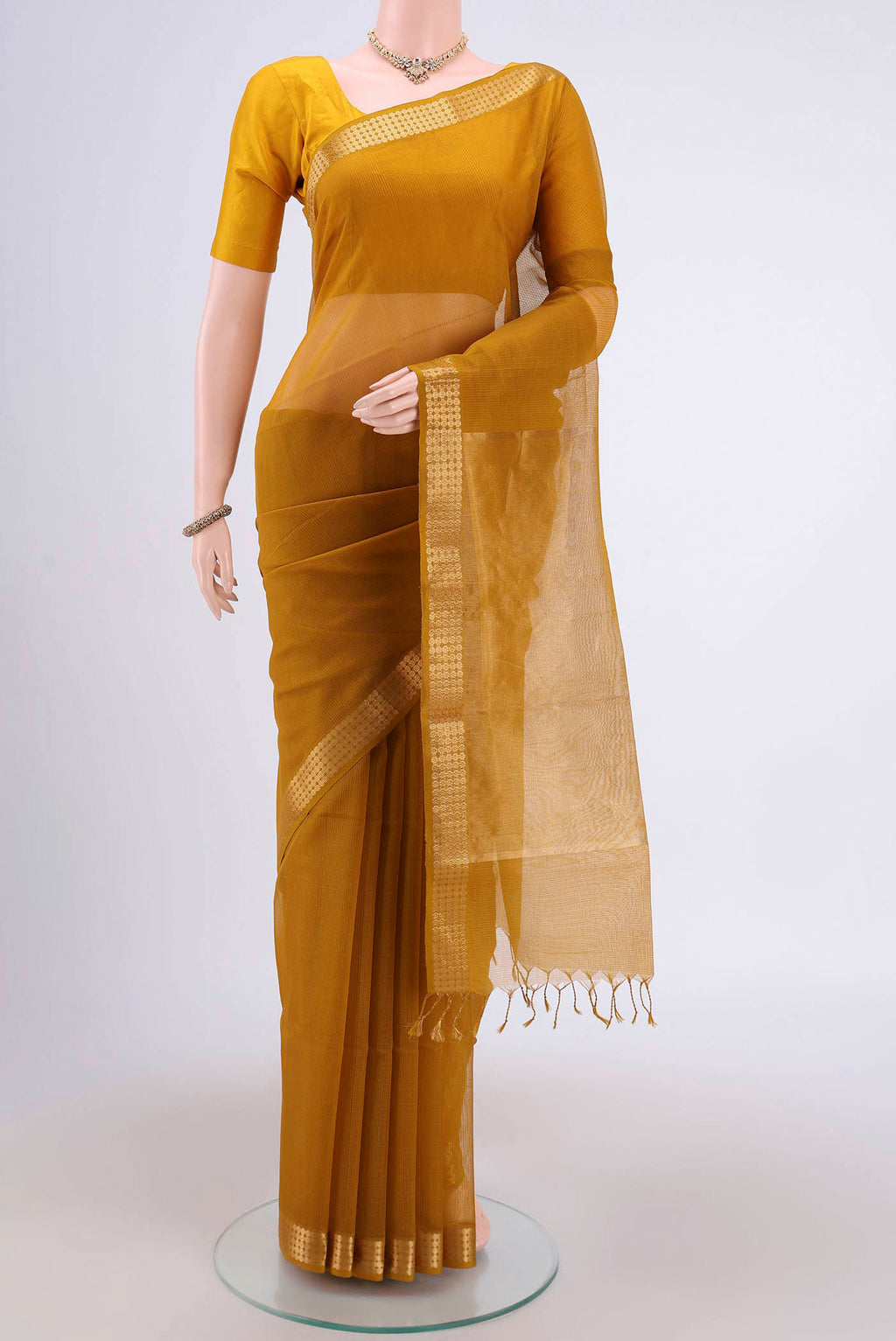 Mustard Maheshwari Silk Cotton Saree with Stripes on the body and Zari Border.  displayed on a mannequin