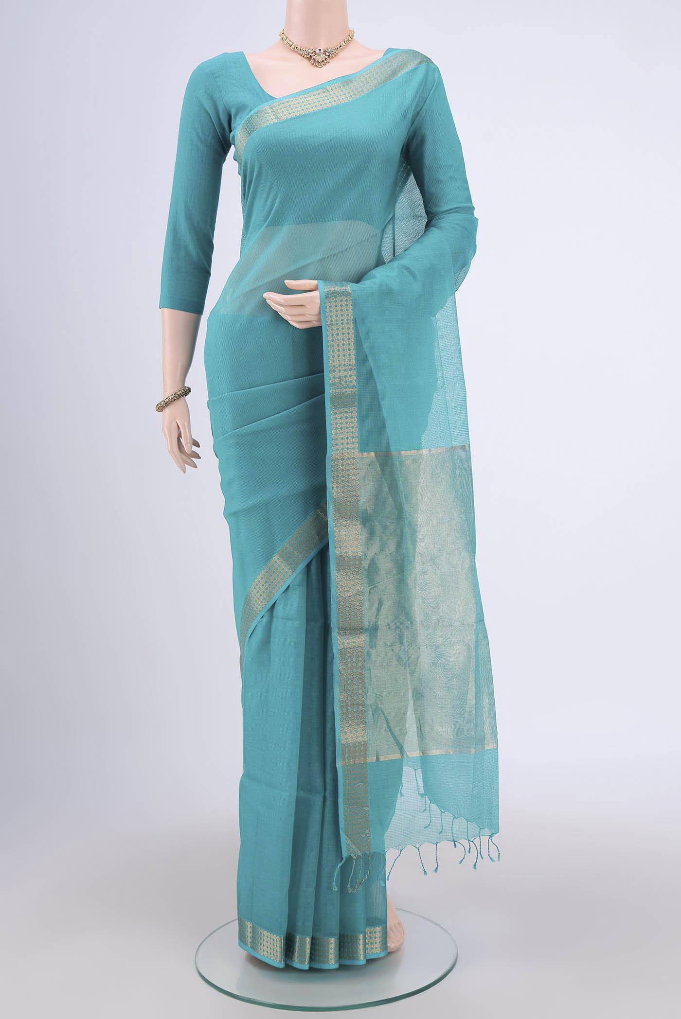 Turquoise Maheshwari Silk Cotton Saree with Plain Body and Zari Border.  displayed on a mannequin