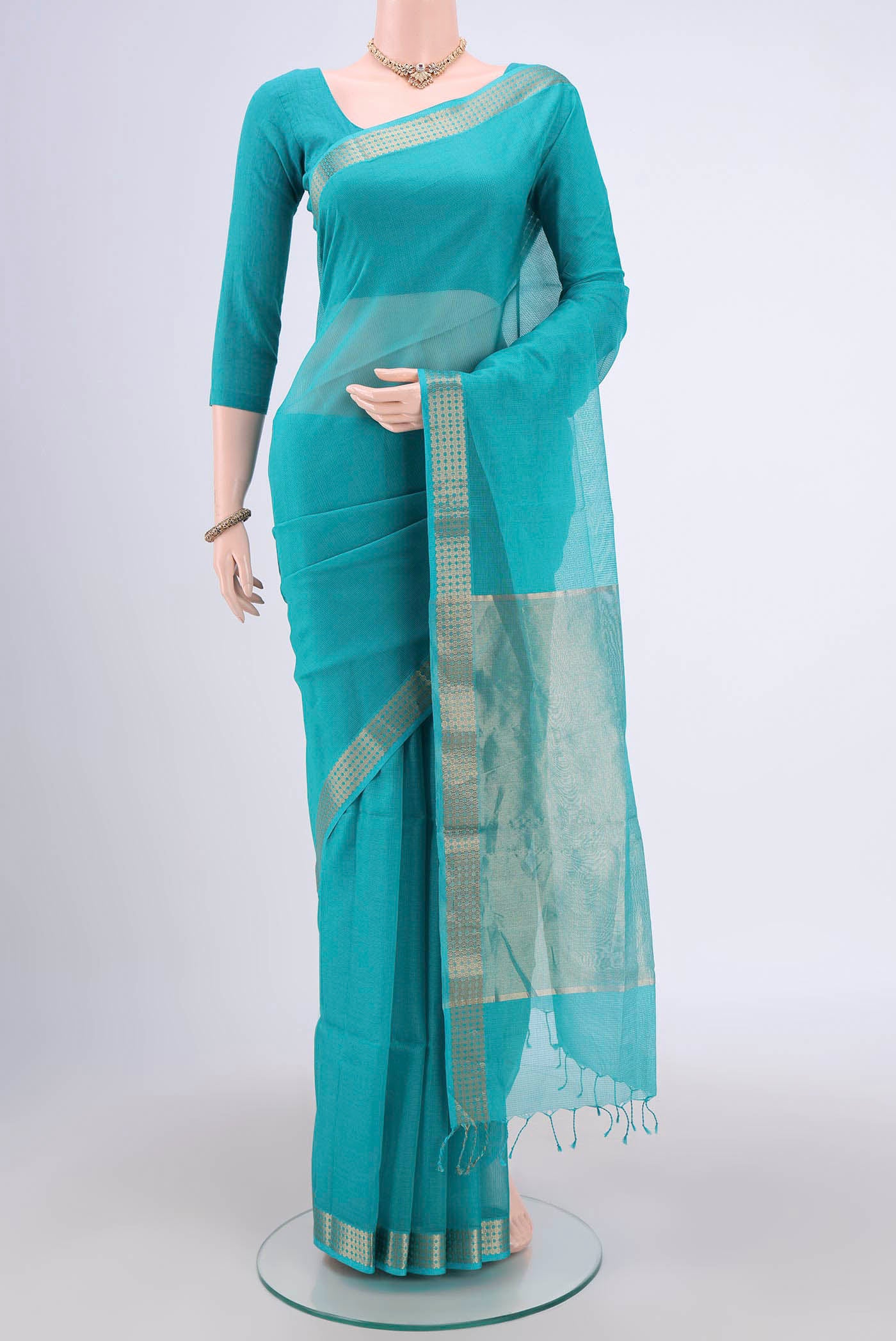Turquoise Maheshwari Silk Cotton Saree with Plain Body and Zari Border.  displayed on a mannequin