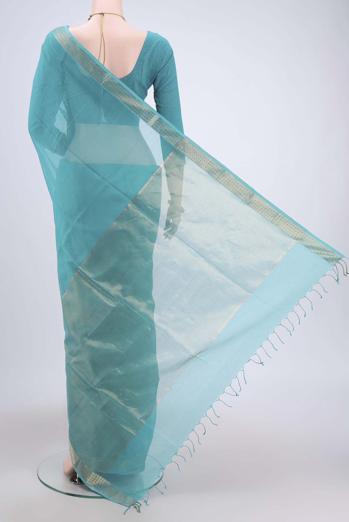 Flat view of Turquoise Maheshwari Silk Cotton Saree with Plain Body and Zari Border. 