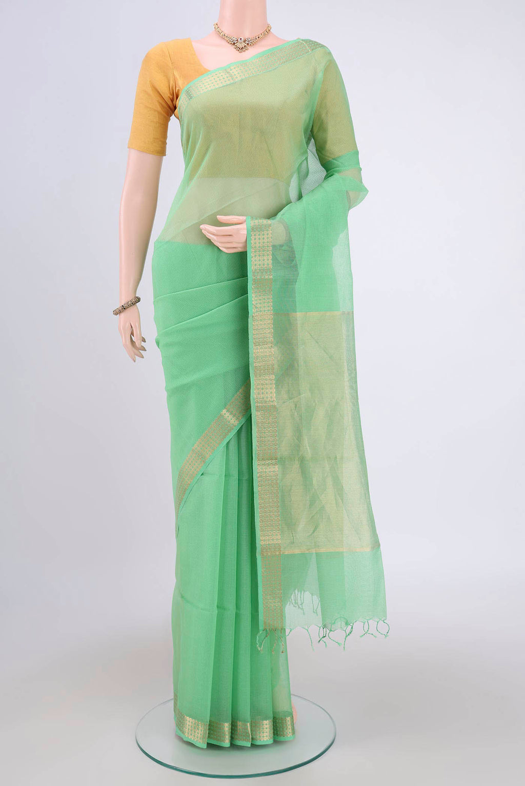 Light Green Maheshwari Silk Cotton Saree with Plain Body and Zari Border.  displayed on a mannequin