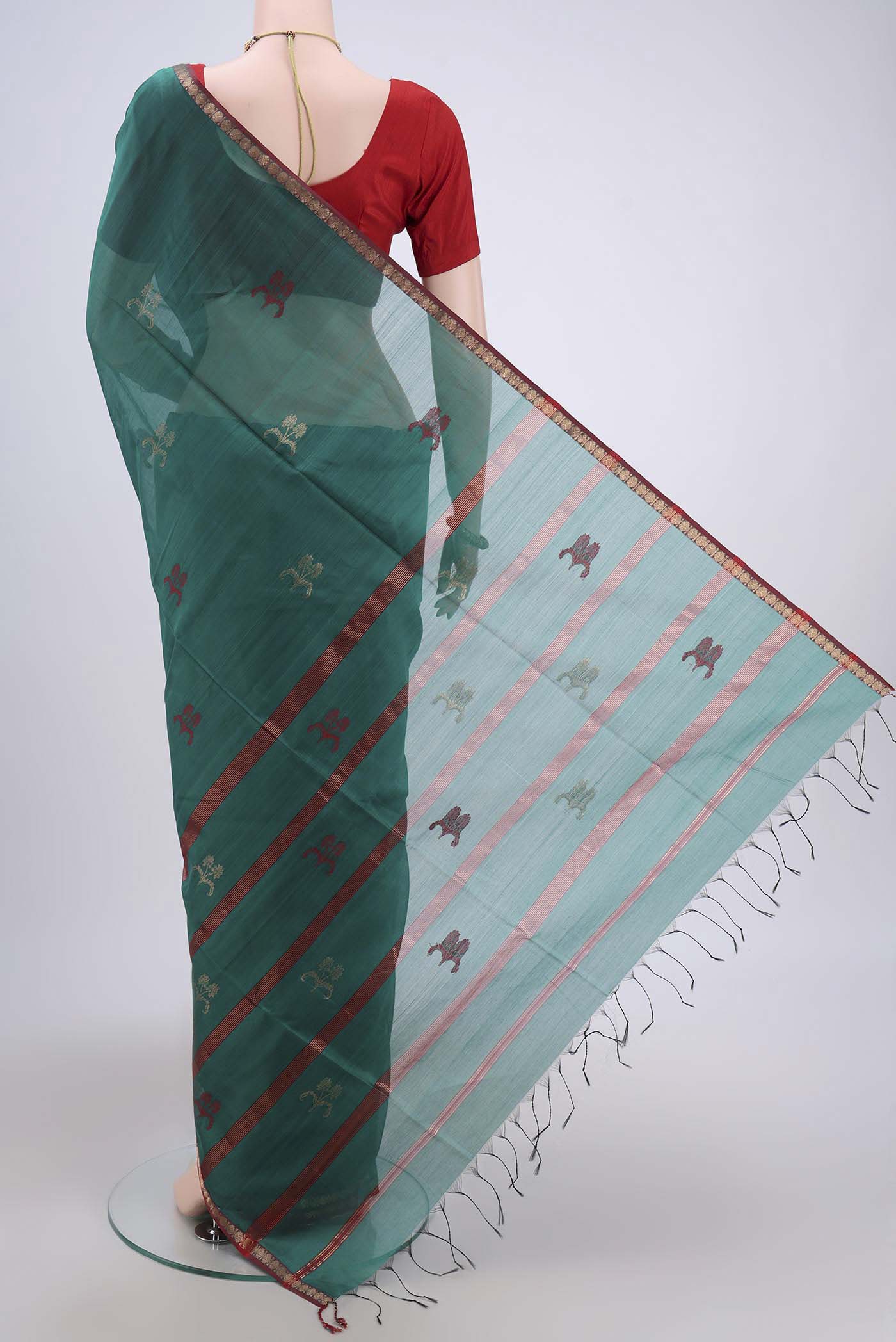 Flat view of Sea Green Maheshwari Silk Cotton Saree with Zari And Thread Butta on the body and Zari Border. 