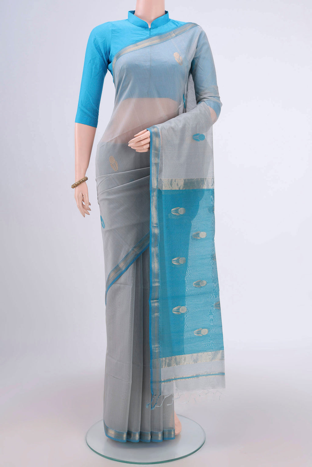 Grey Maheshwari Silk Cotton Saree with Stripes on the body and Zari Border.  displayed on a mannequin